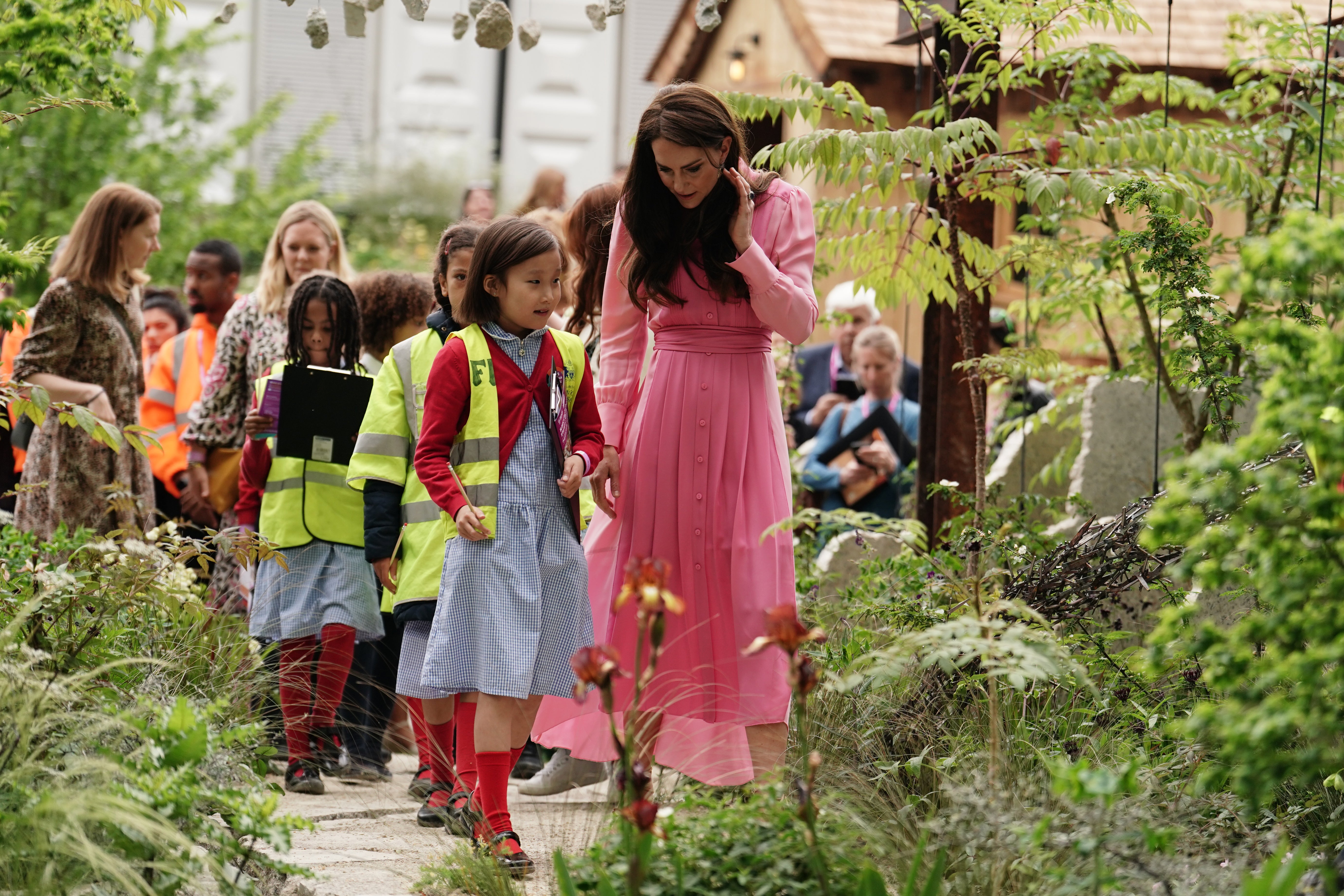 Catherine, Princess of Wales talks with pupils, after taking part in the first Children's Picnic at the RHS Chelsea Flower Show, at the Royal Hospital Chelsea