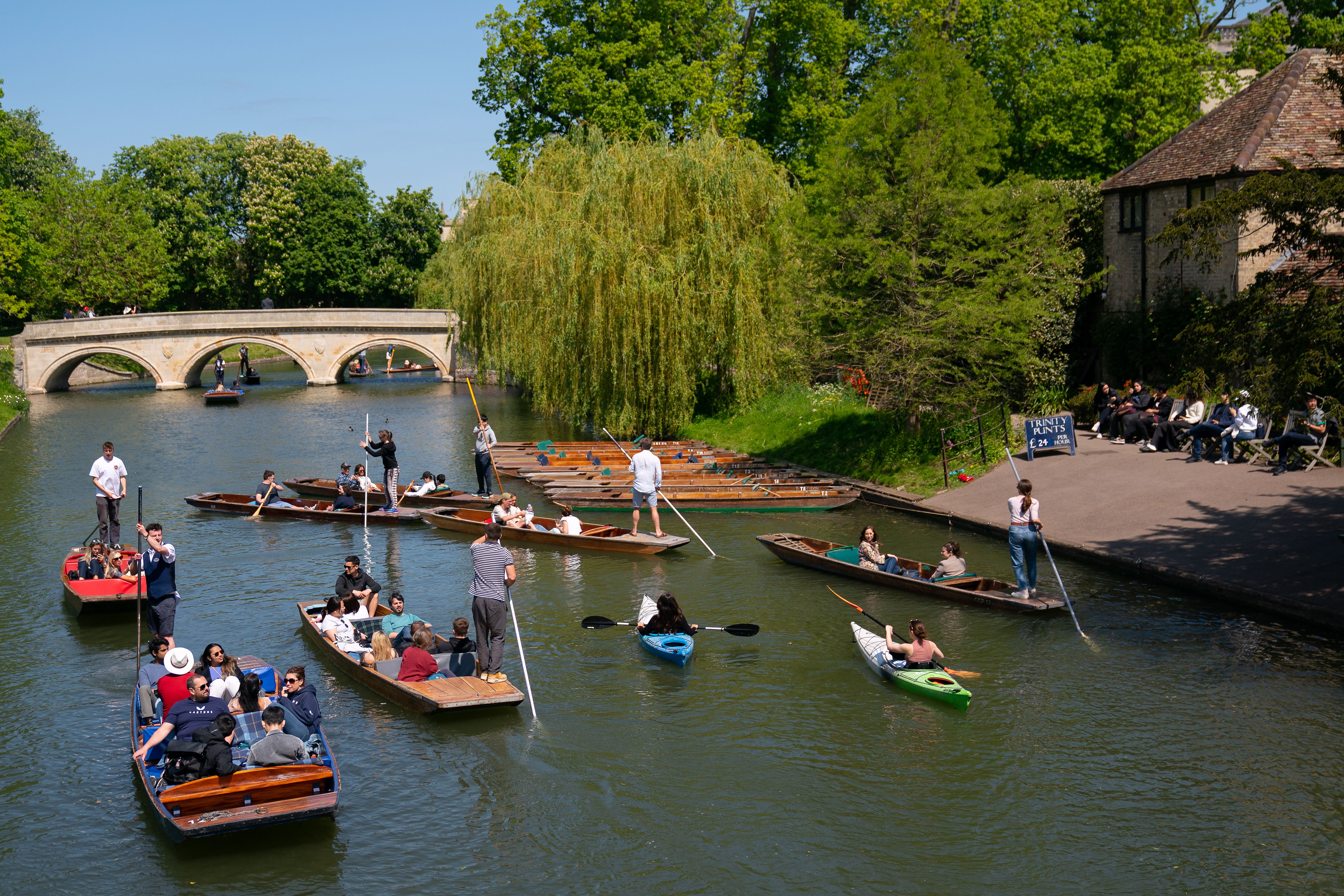 People enjoy the warm weather as they take punt tours along the River Cam in Cambridge (Joe Giddens/PA)