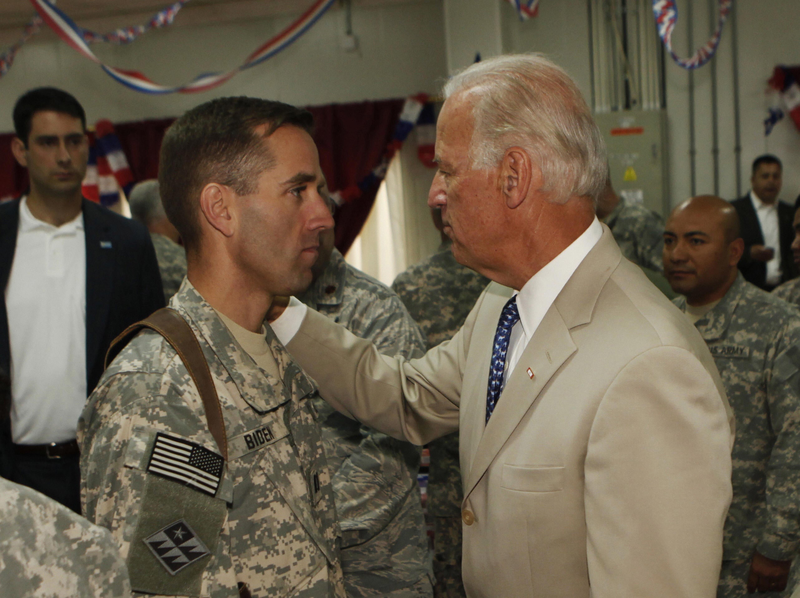 Then US vice president Joe Biden (right) talks with his son, US Army Capt Beau Biden (left) at Camp Victory on the outskirts of Baghdad on 4 July 2009