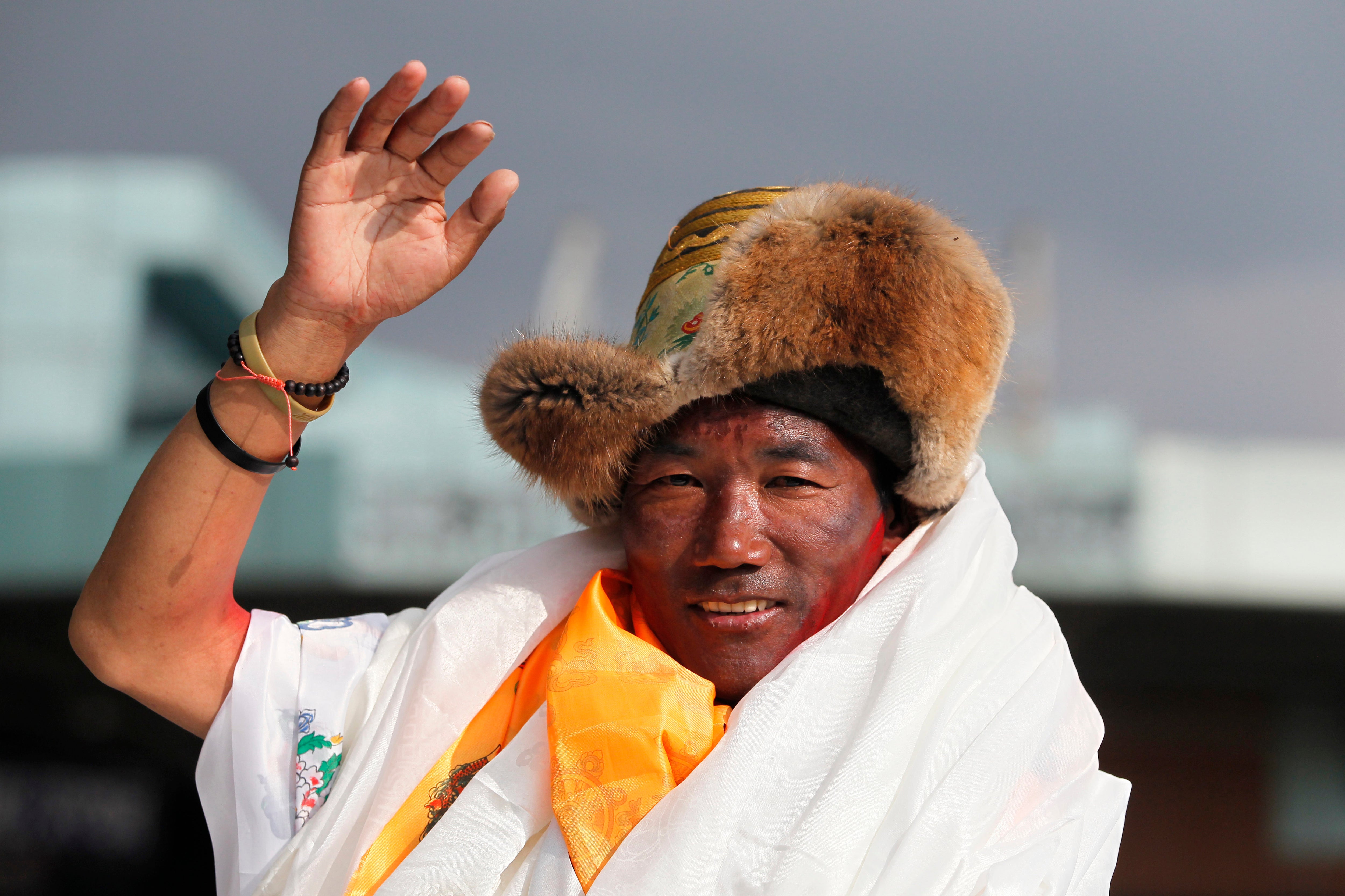 Nepalese veteran Sherpa guide Kami Rita waves as he arrives in Kathmandu, Nepal