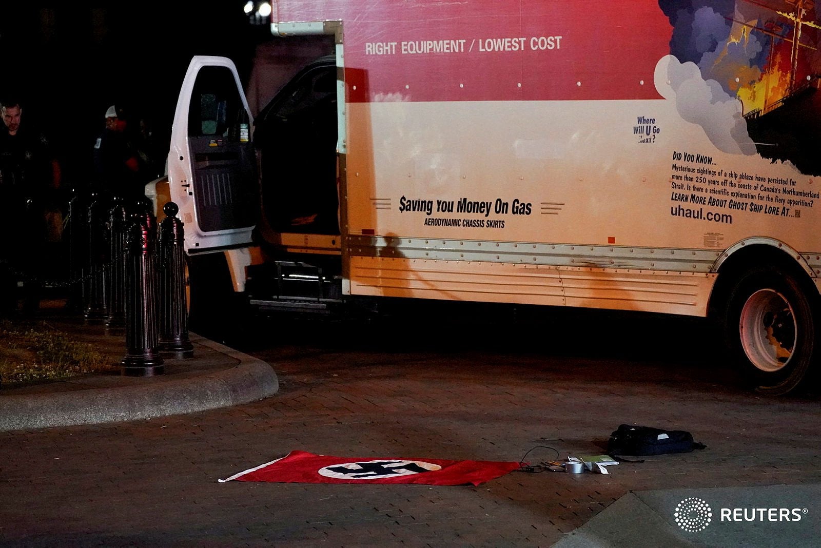 A Nazi flag and other objects recovered from a rented box truck lie on the ground as the US Secret Service investigates the truck that crashed into security barriers at Lafayette Park, across from the White House in Washington