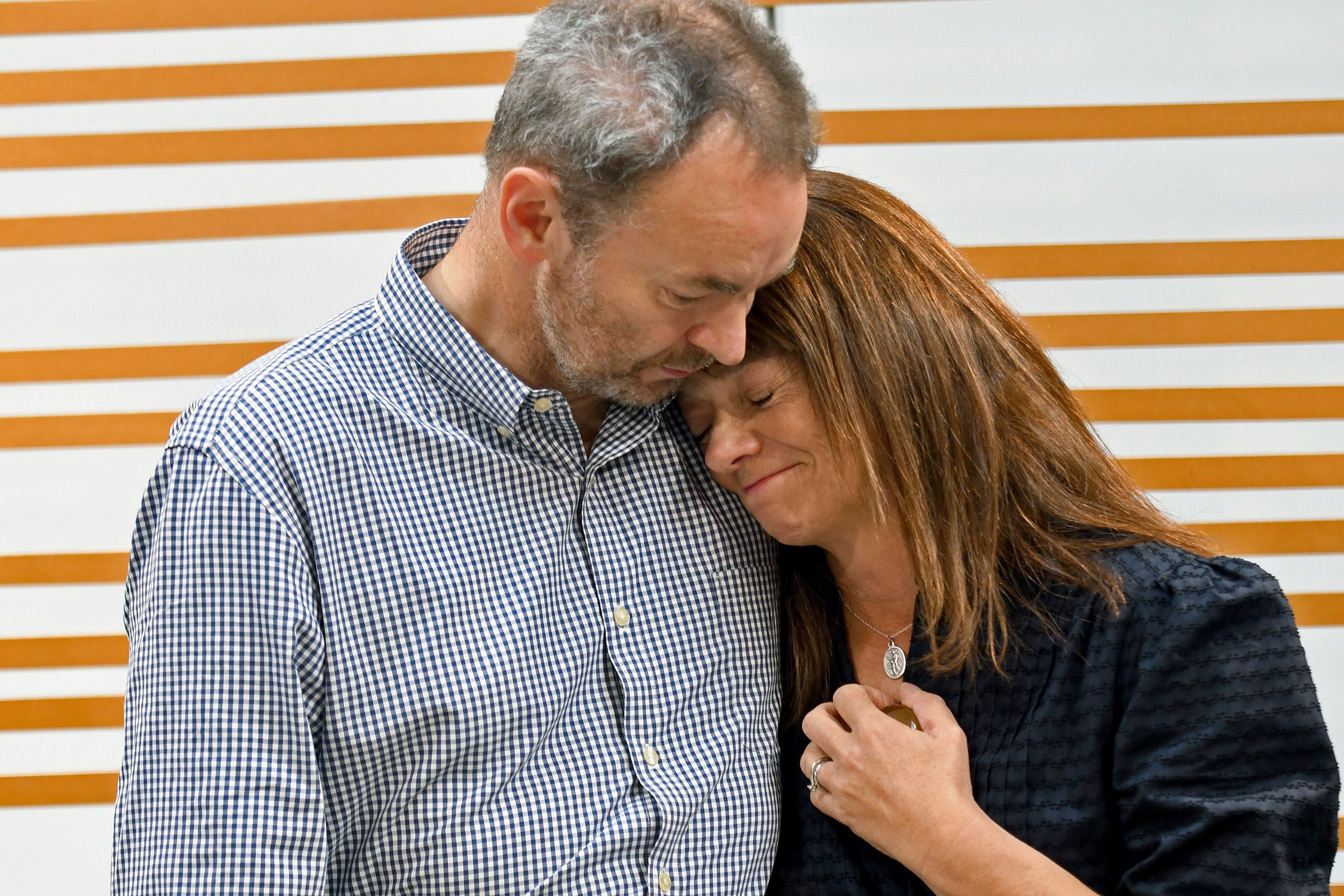 Simon and Sally Glass comfort each other during an emotional news conference in Denver on Tuesday, Sept. 13, 2022