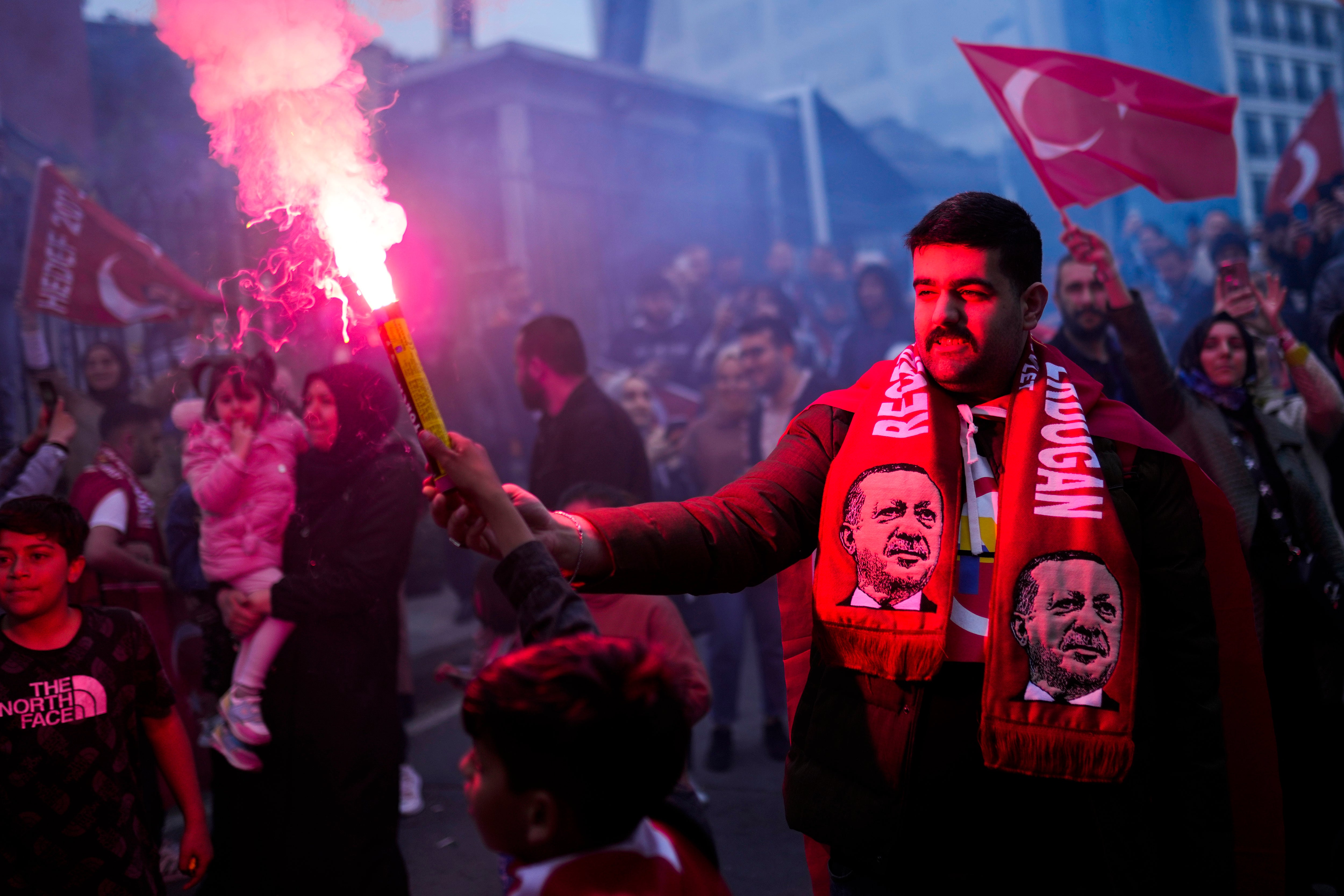 Supporters of Mr Erdogan cheer outside the headquarters of his Justice and Development Party (AKP) in Istanbul after the first round of voting earlier this month