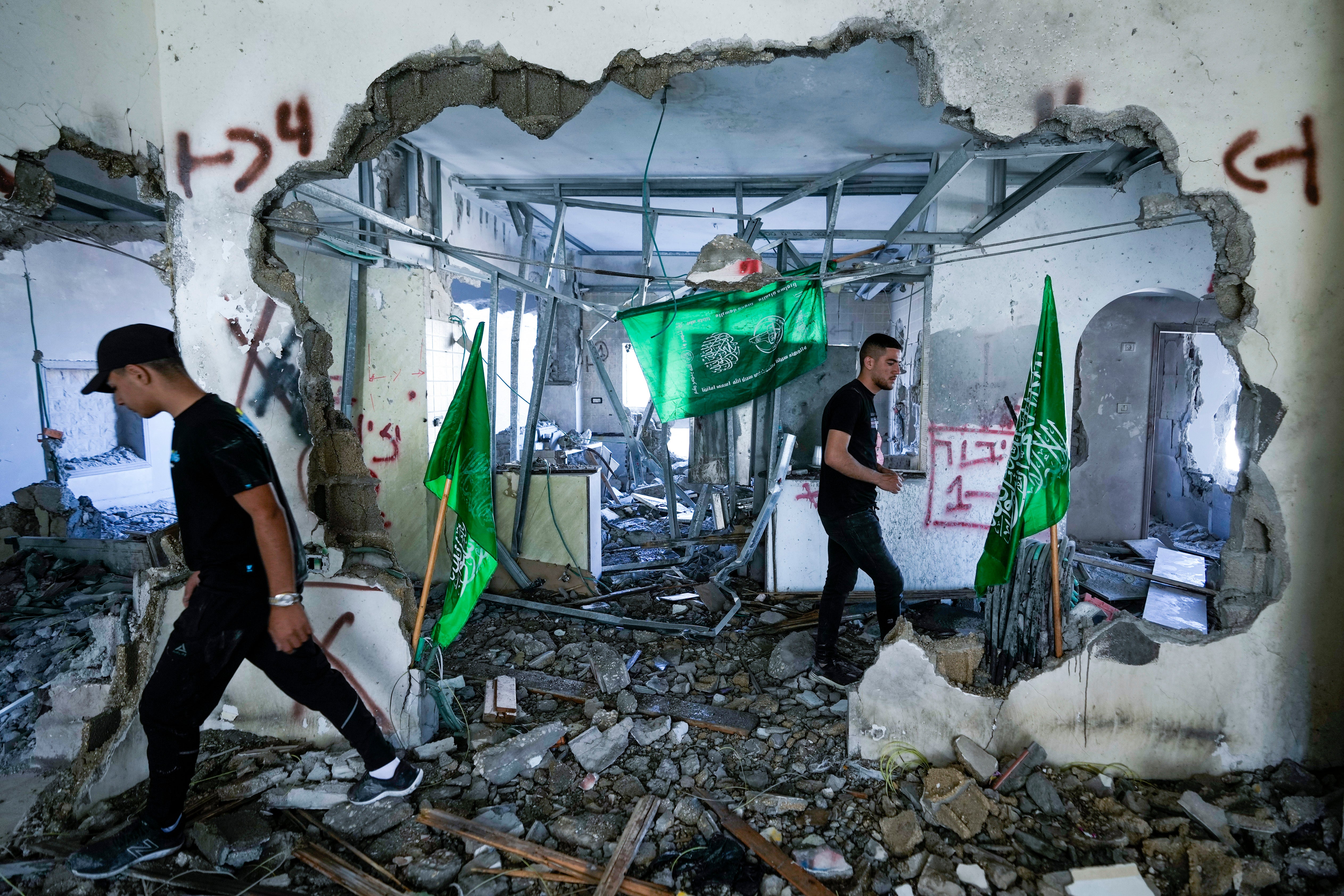 Palestinians inspect the ruins of the home of a Hamas militant in the occupied West Bank