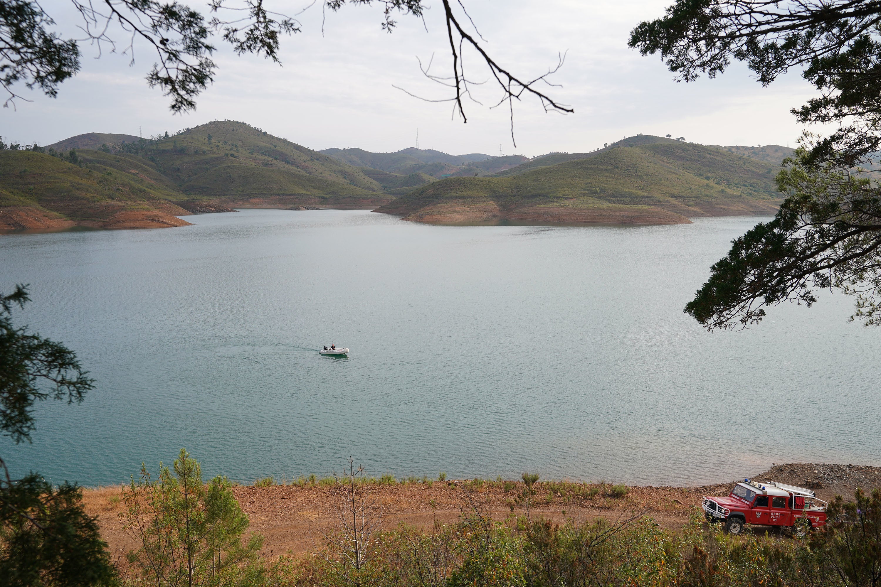 A search boat surveys the reservoir