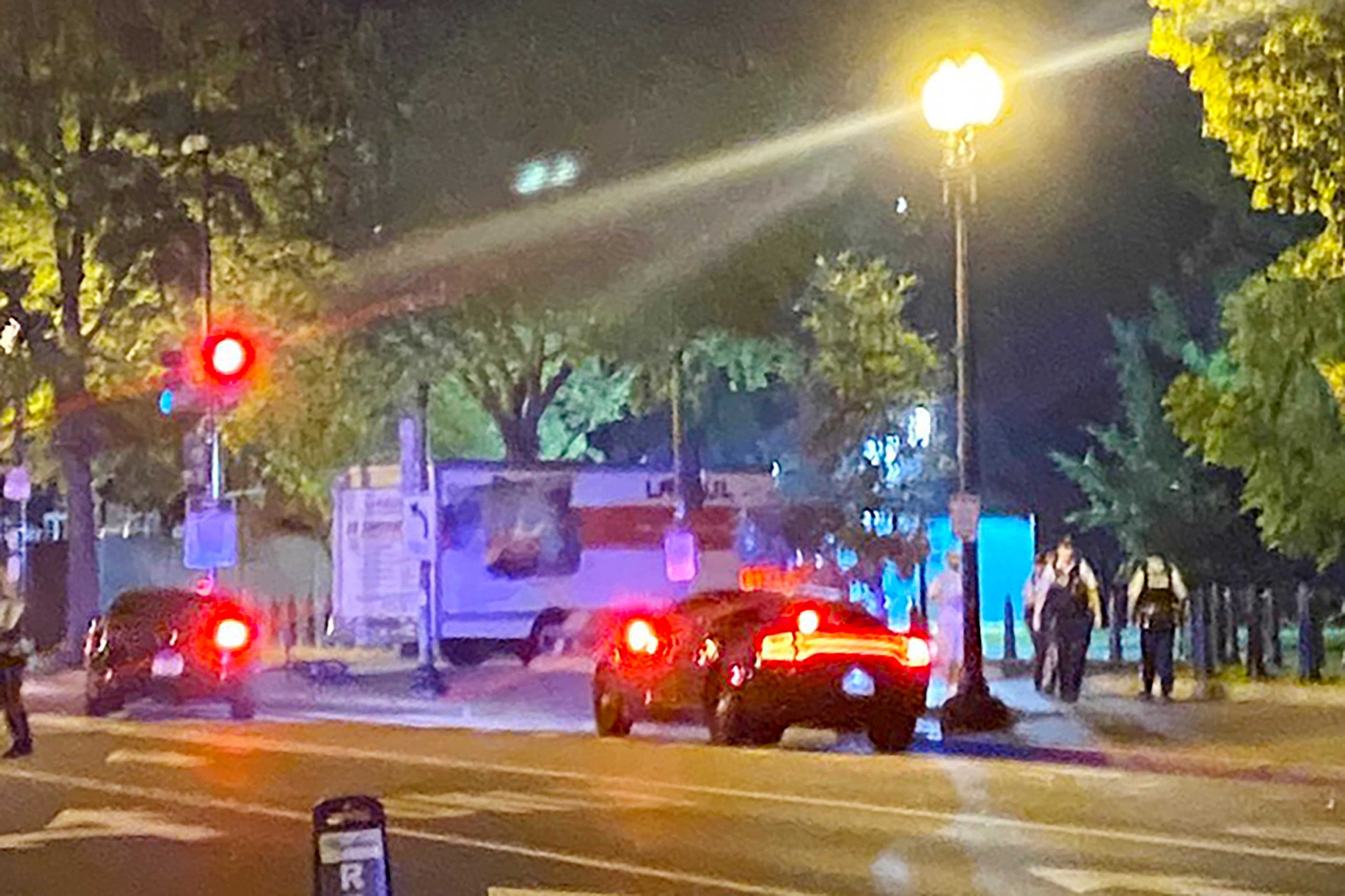 A box truck is seen crashed into a security barrier near the White House