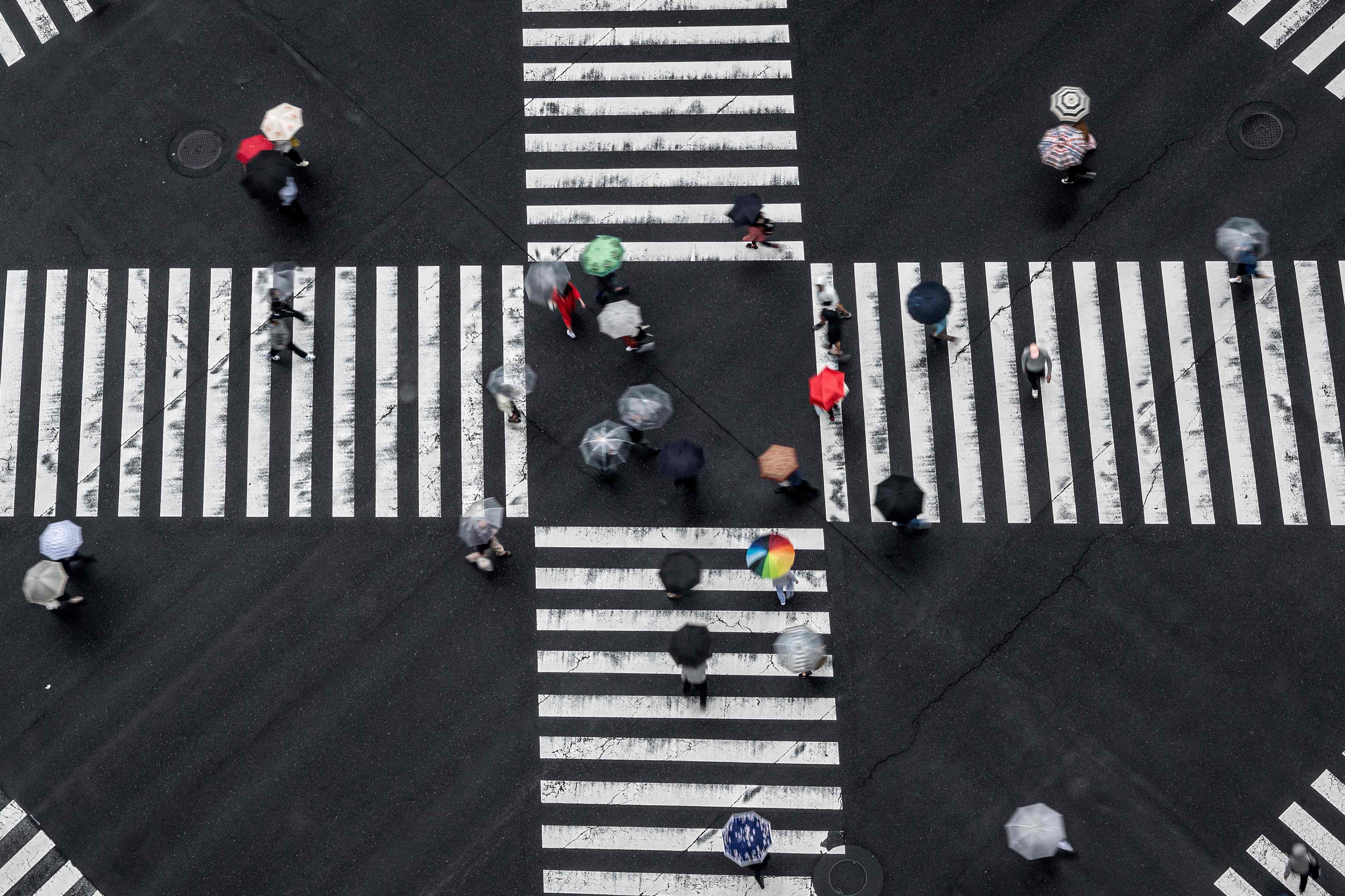 Pedestrians cross an intersection in the rain in the Ginza district of Tokyo