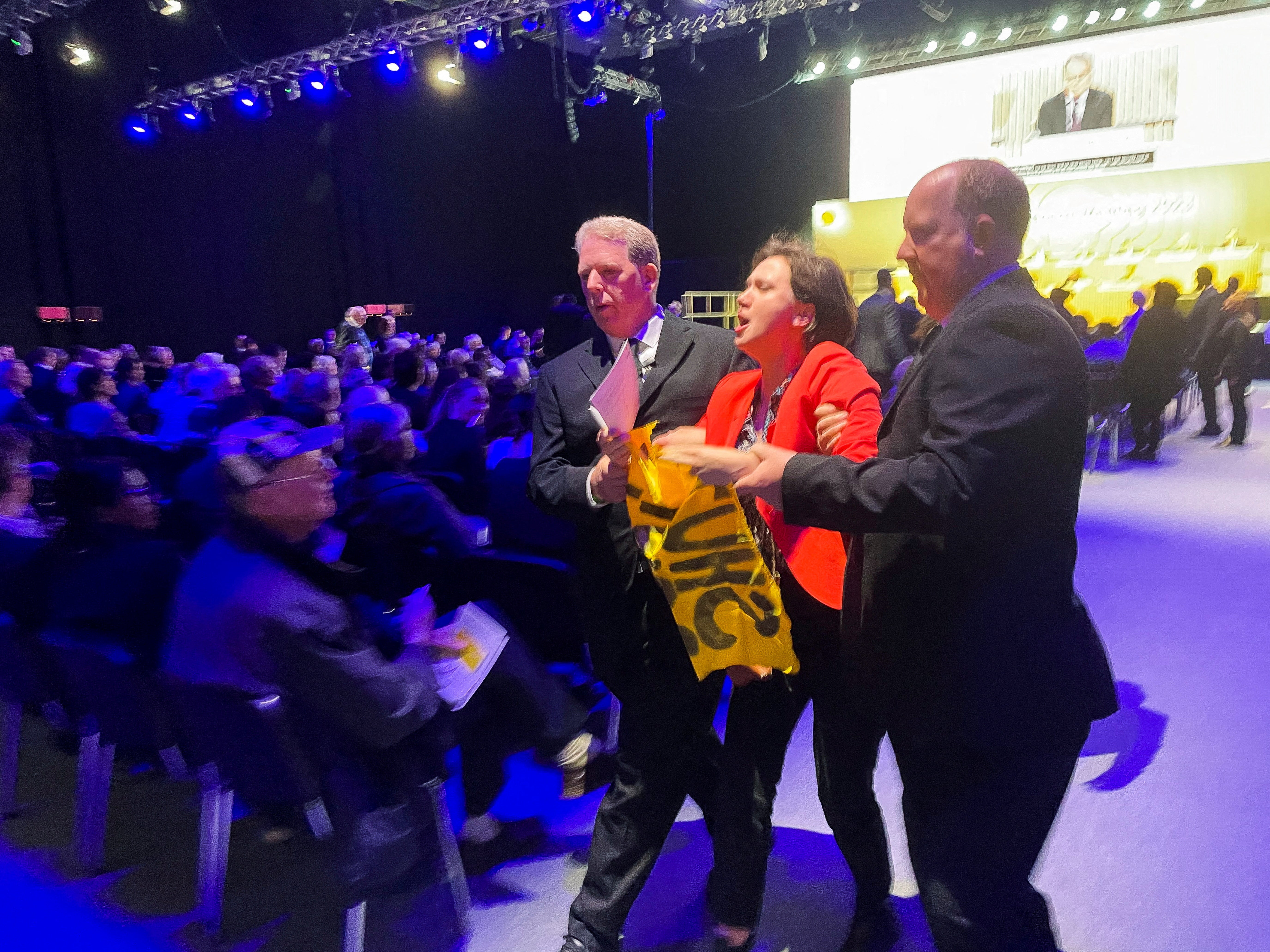 A climate activist is removed after disrupting Shell’s annual general meeting in London on Tuesday