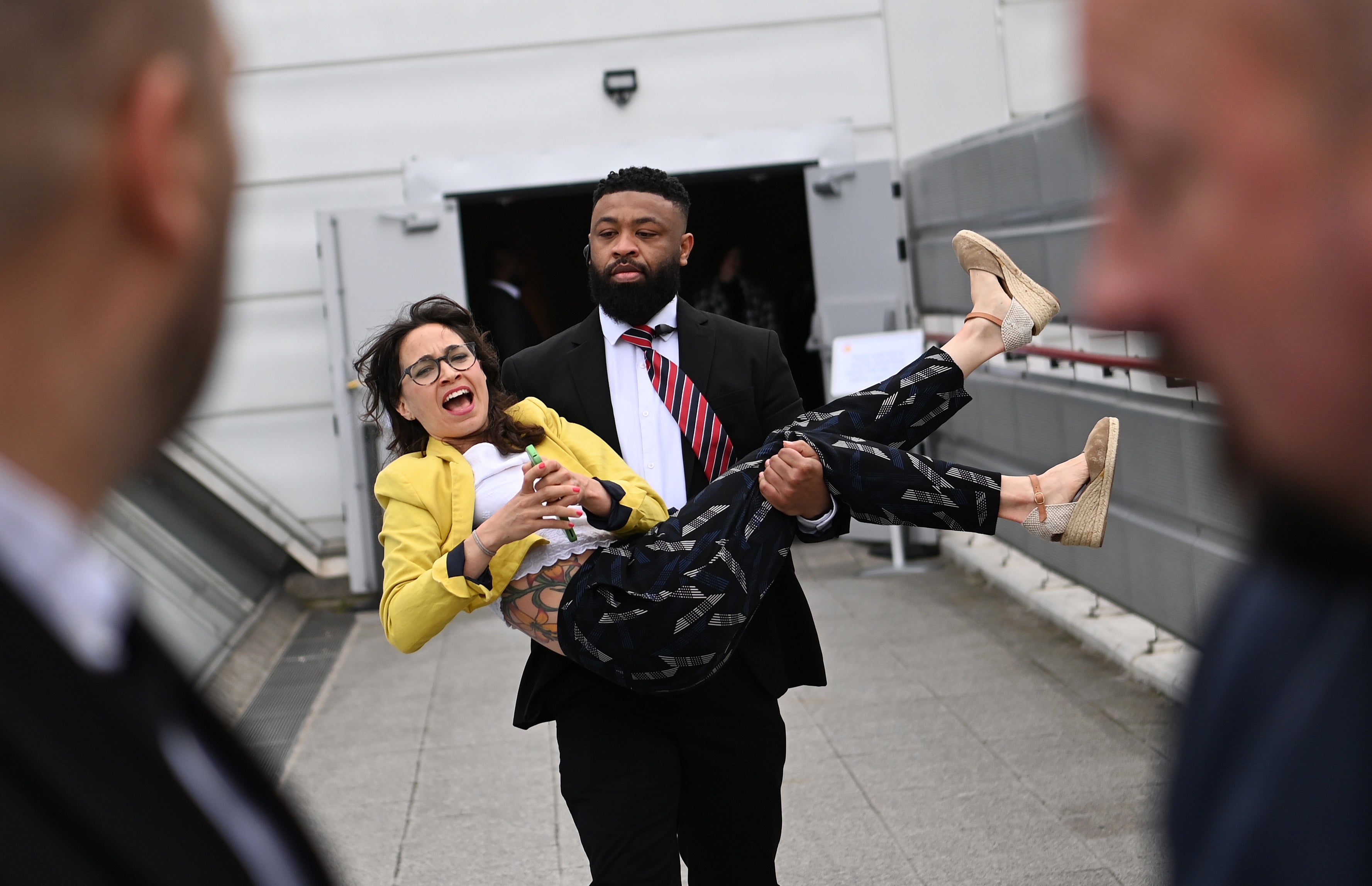 A protester is carried out of the Shell annual general shareholders meeting in London on Tuesday