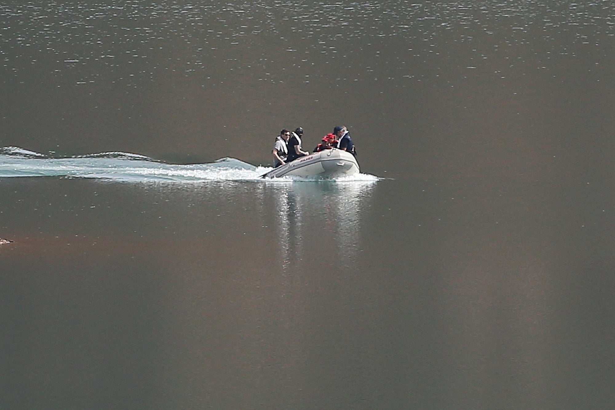 A search dingy navigates in the Arade dam near Silves, Portugal