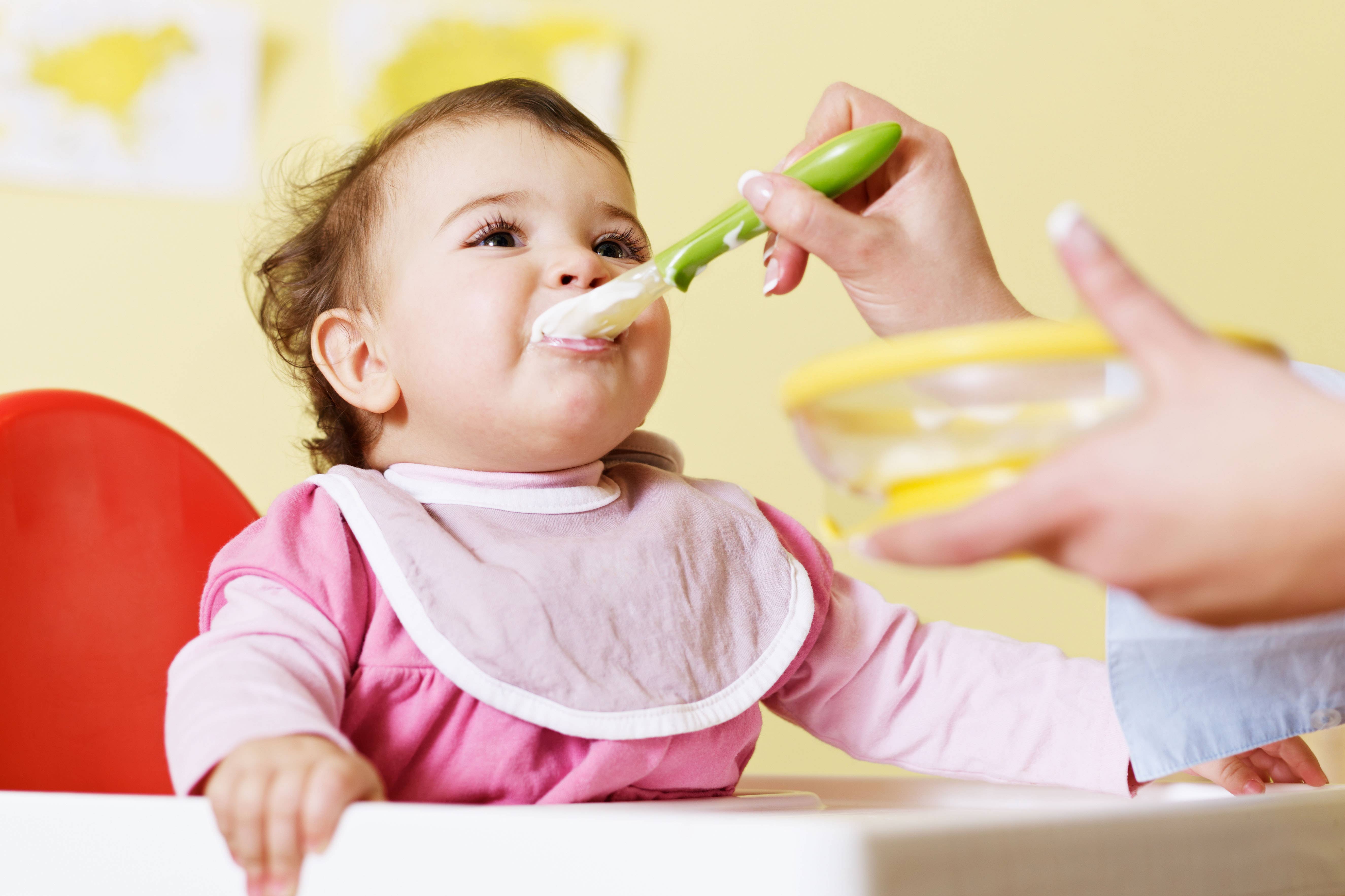 BHF65G mom giving homogenized food to her daughter on high chair. Horizontal shape