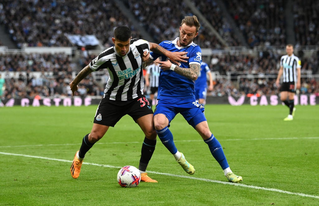 Bruno Guimaraes is challenged by James Maddison during a match