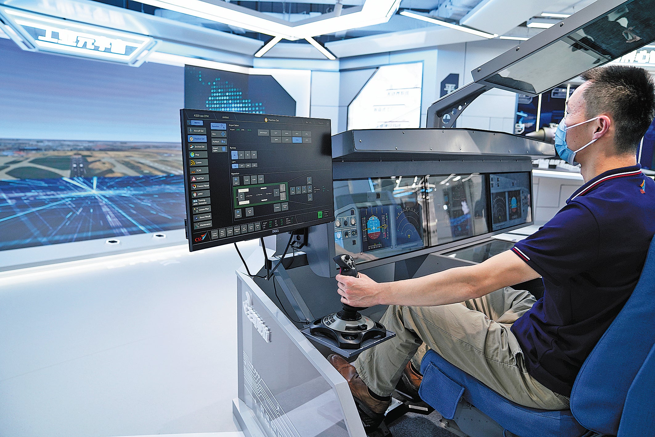 A staff member operates a pilot simulator at a digital exhibition centre in Shanghai.