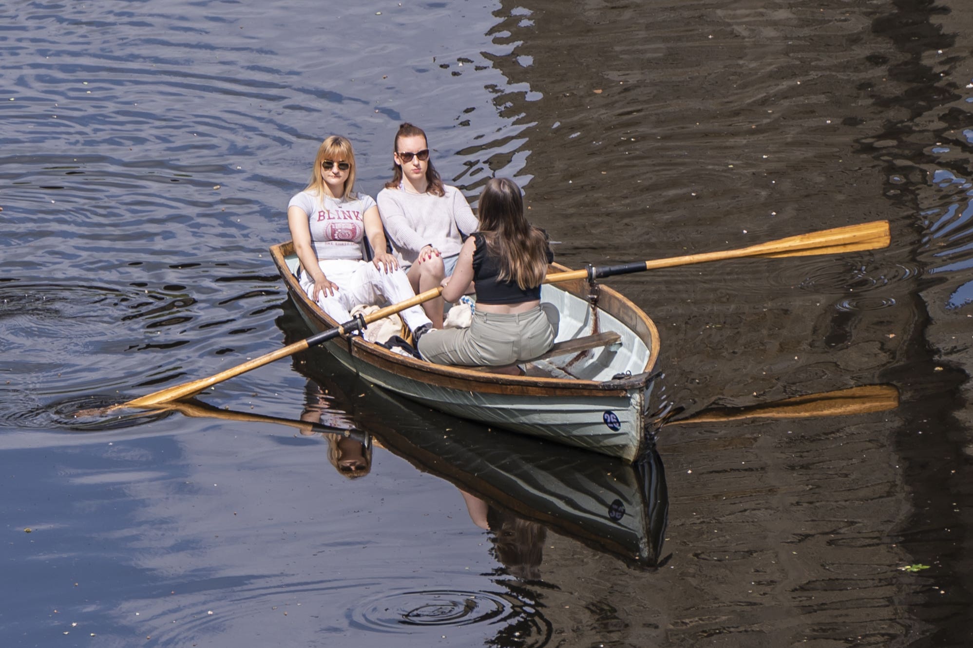 People enjoy the hot weather in a rowing boat on River Nidd in Knaresborough, North Yorkshire (Danny Lawson/PA)