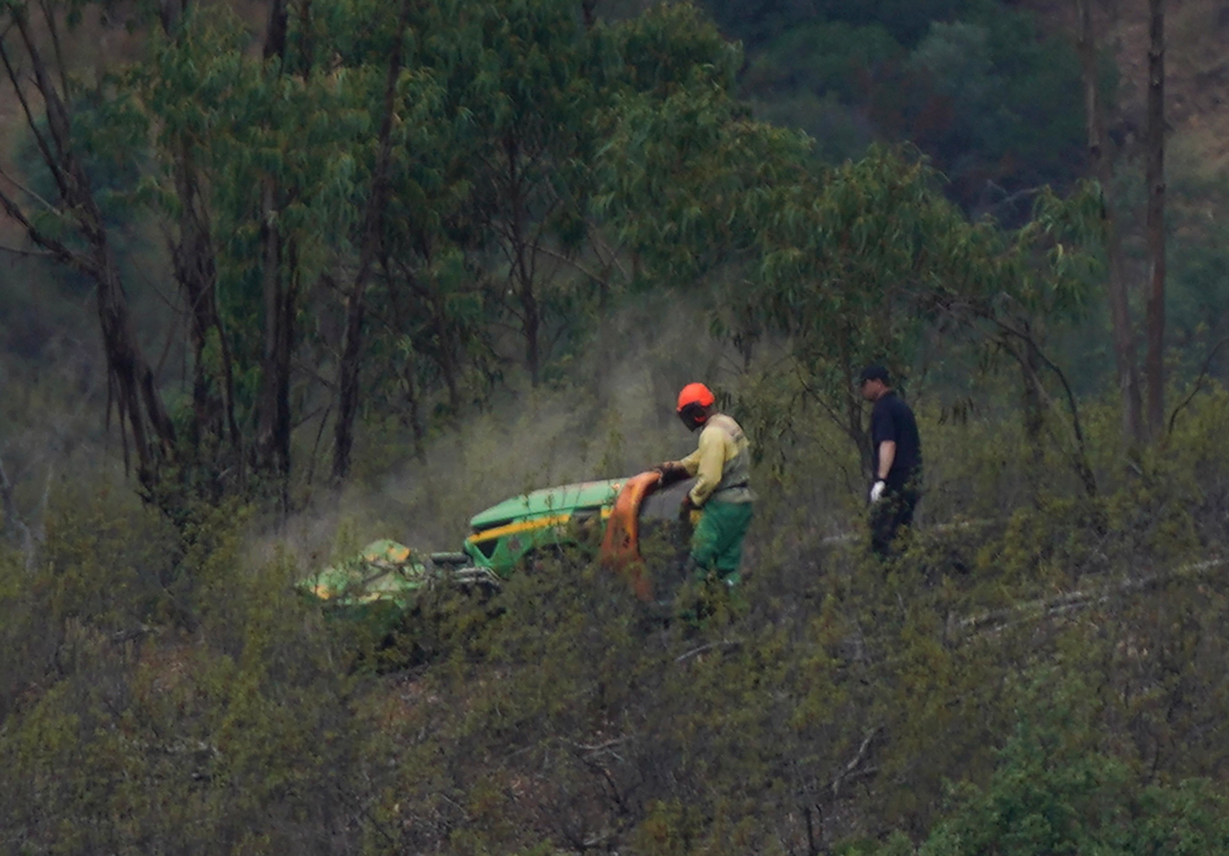 Personnel clear undergrowth with machinery at Barragem do Arade reservoir