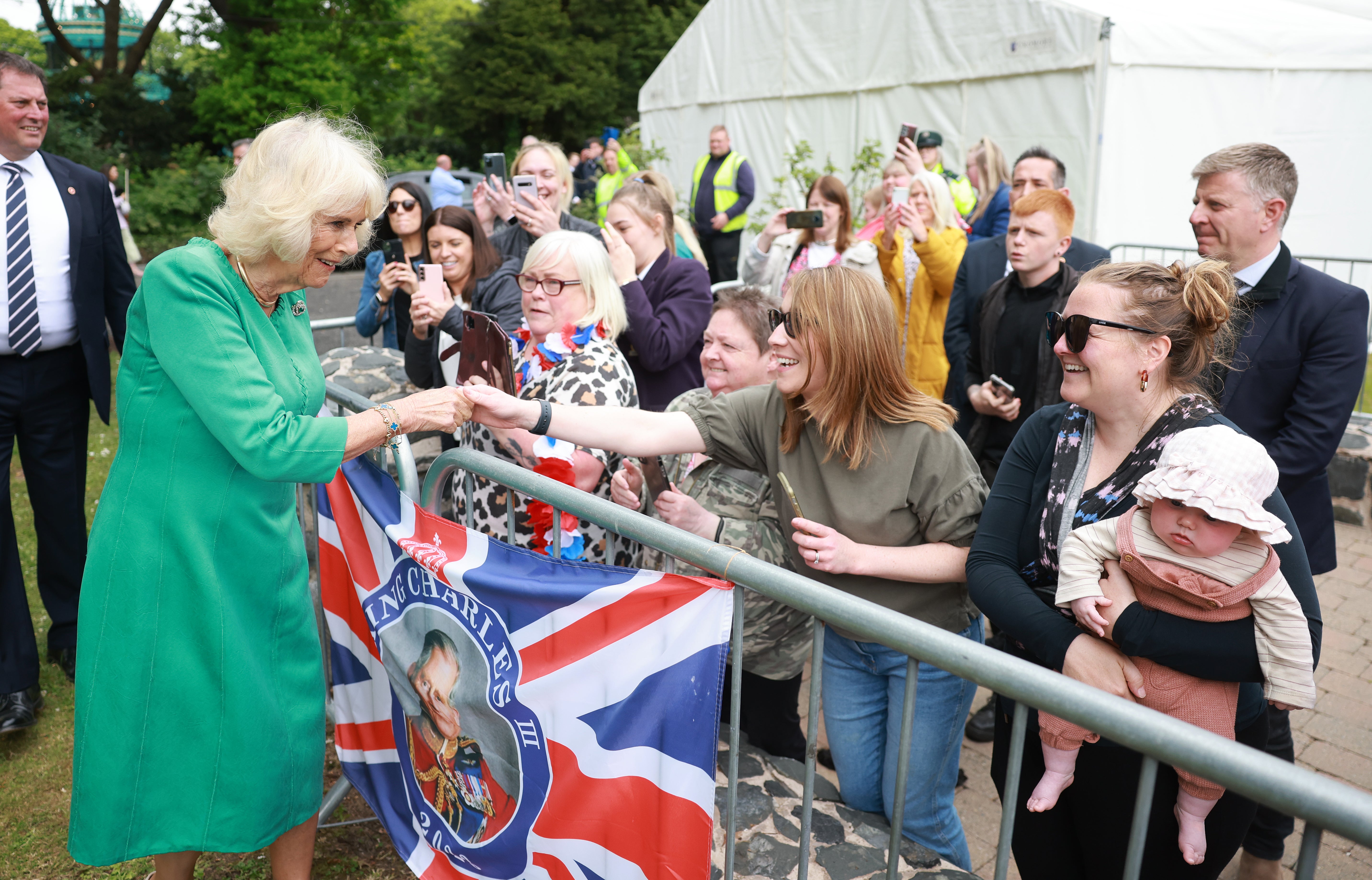 Queen Camilla greets the crowd after a visit to open the new Coronation Garden on day one of their two-day visit to Northern Ireland