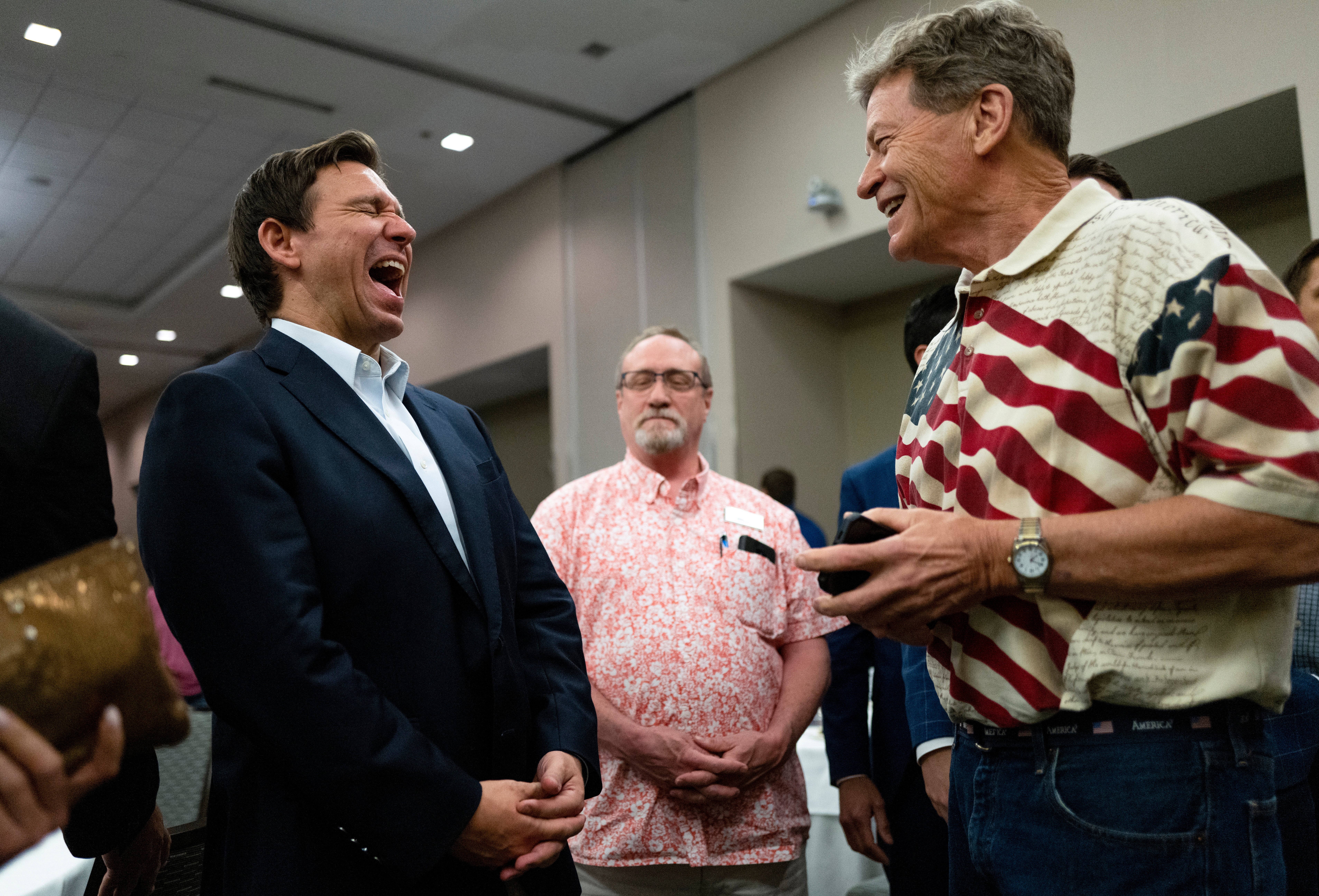 DeSantis laughs with voters at an Iowa GOP receptio in Cedar Rapids, Iowa