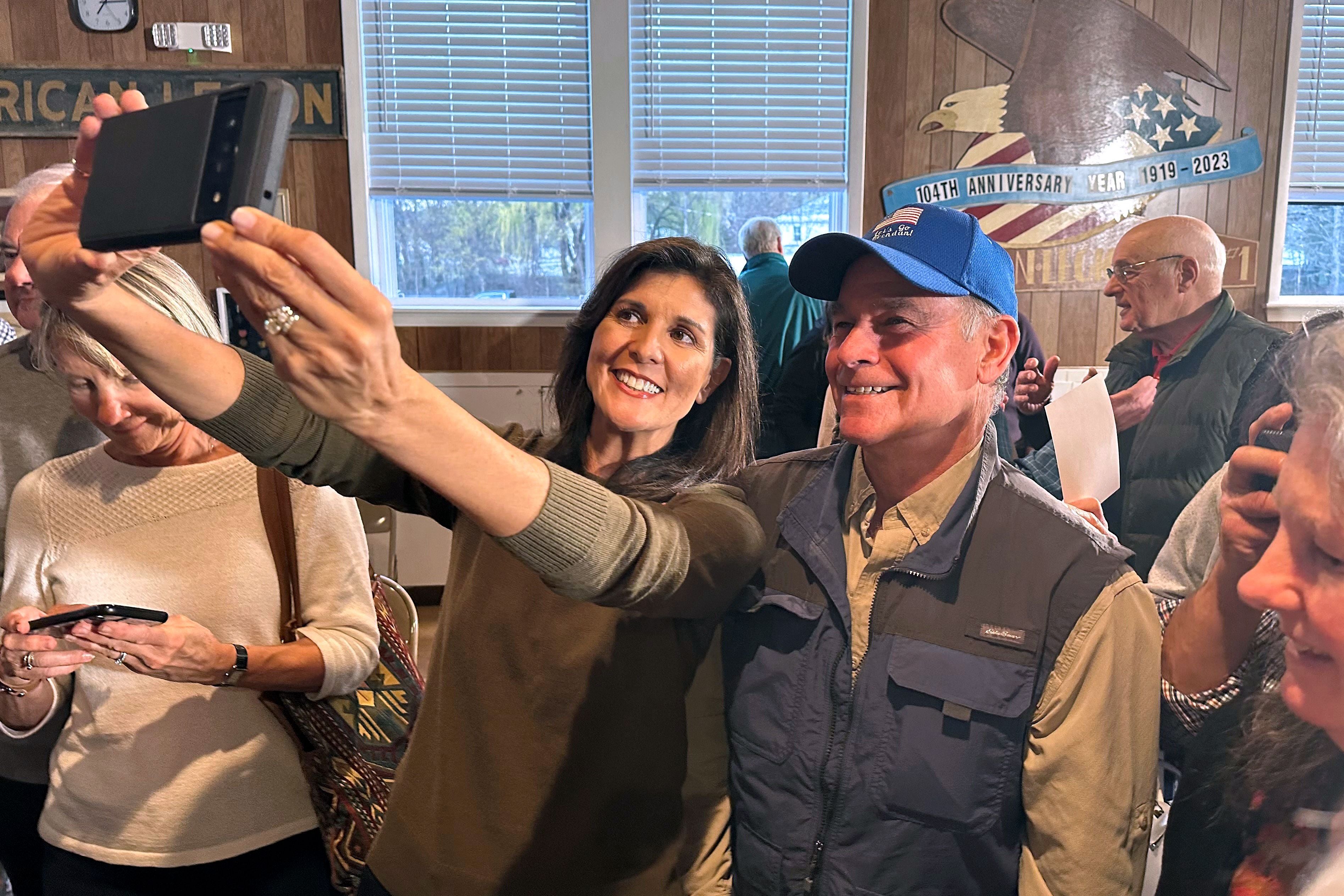 Nikki Haley takes a picture with a supporter following a town hall event at an American Legion center in Laconia, New Hampshire in April