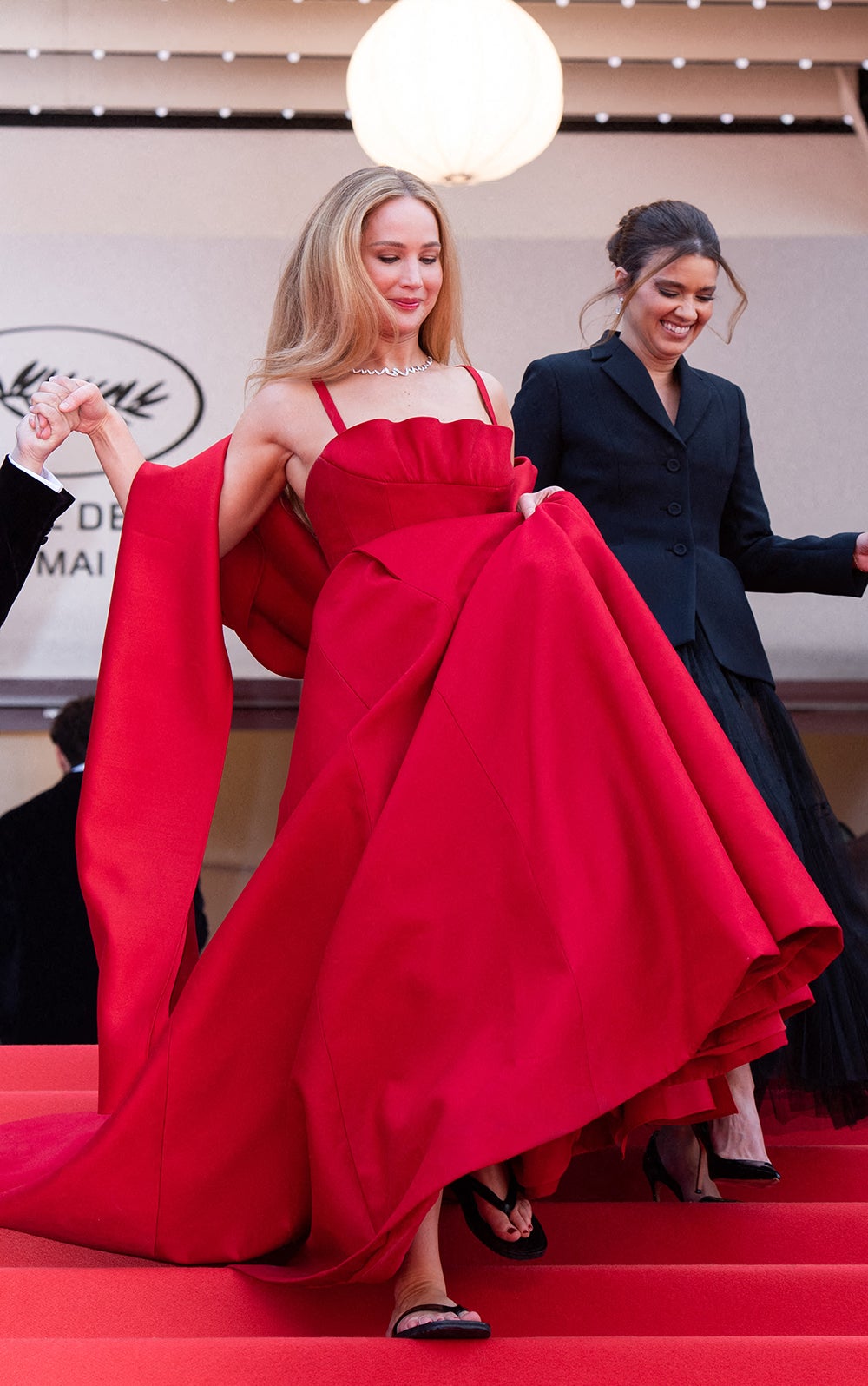 Jennifer Lawrence sports flip-flops beneath her Dior dress on the Cannes red carpet