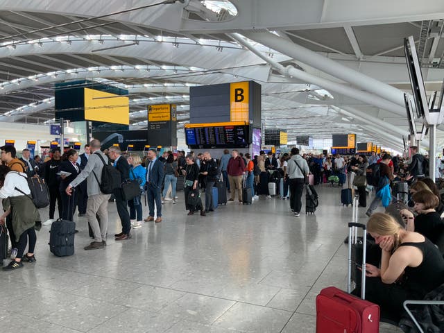 <p>Passengers waiting to be rebooked at Heathrow after mass cancellations</p>