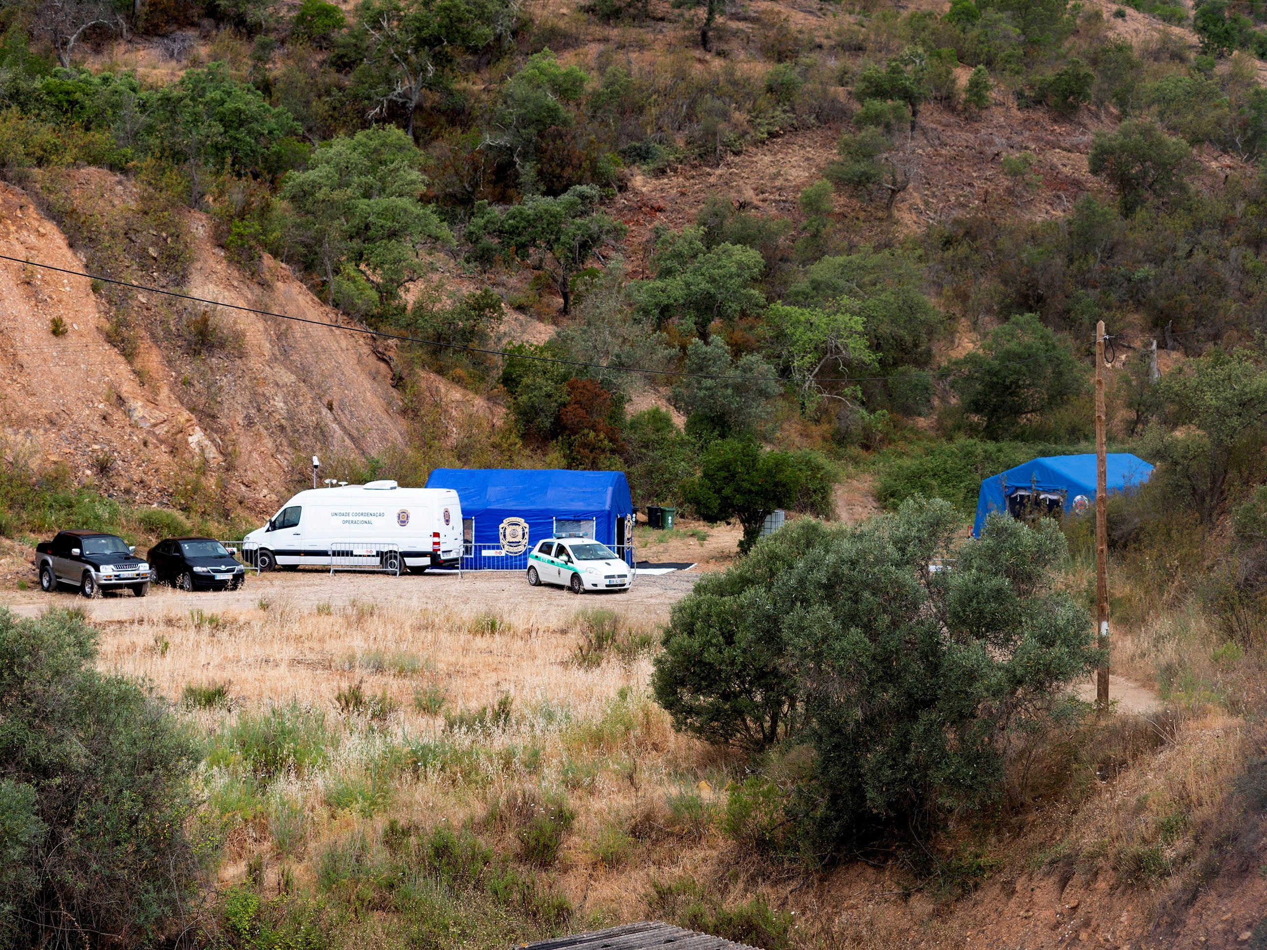 Vehicles and tents of Portugal's investigative Judicial Police are seen at the site of a remote reservoir where a new search for the body of Madeleine McCann took place, in Silves, Portugal