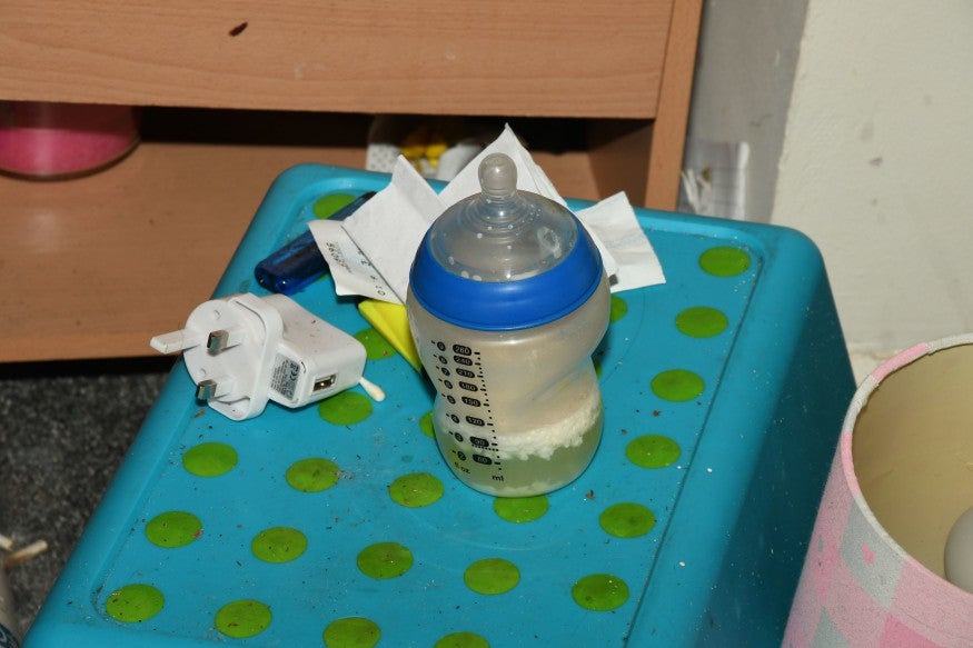 Old baby formula was pictured next to drug paraphernalia