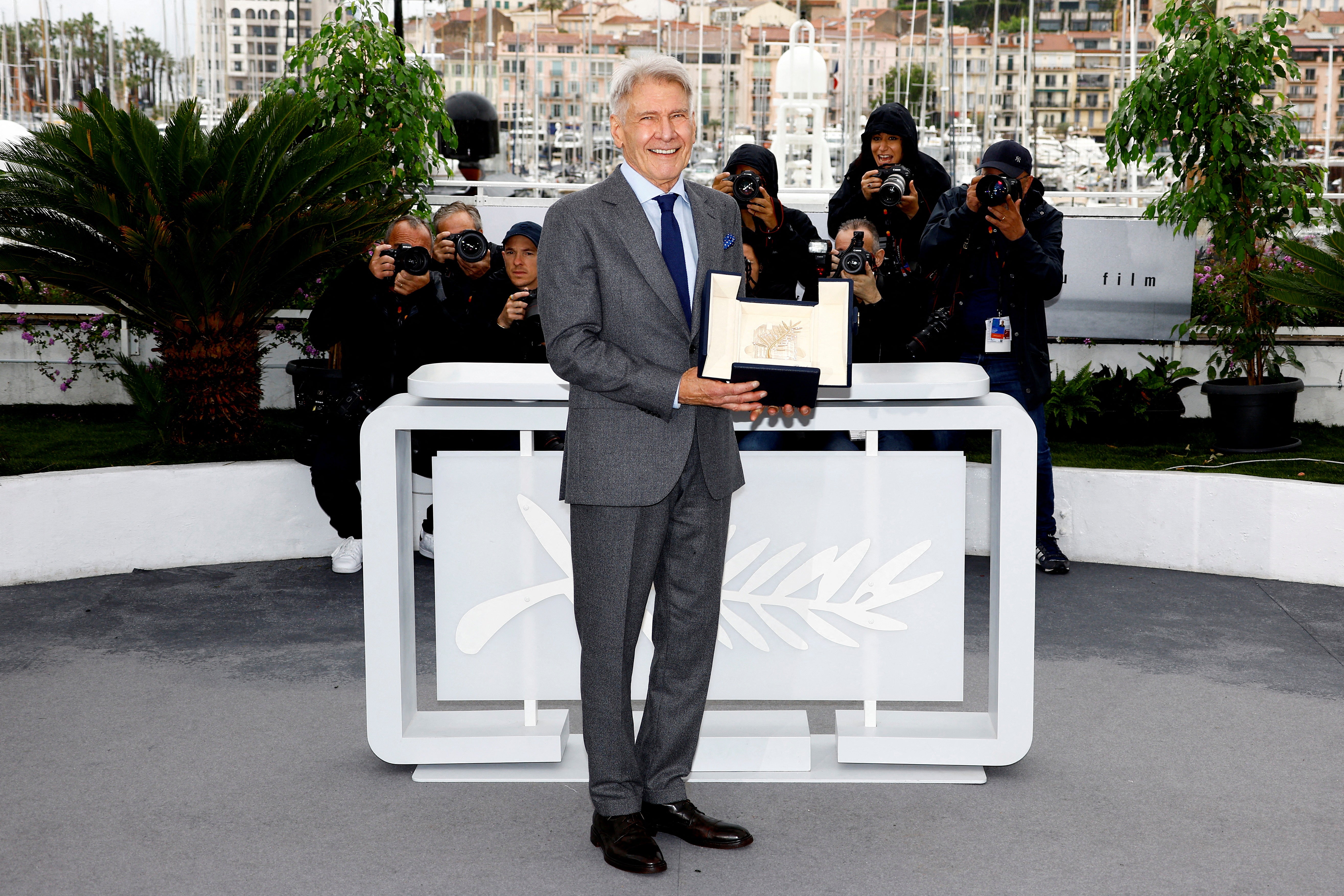 Harrison Ford poses with his honorary Palme d'Or Award at the 76th Cannes on 19 May 2023