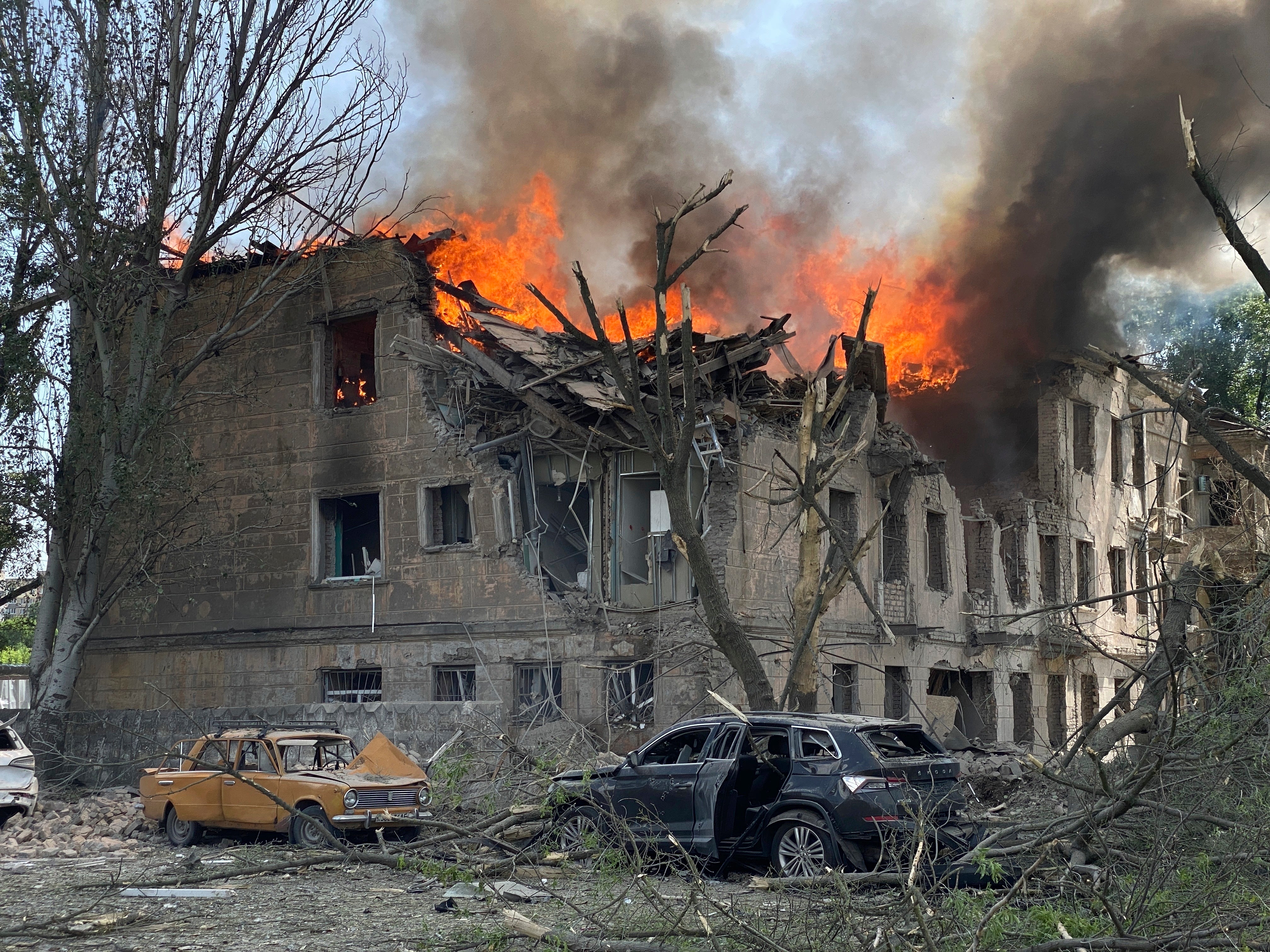 Firefighters hose down a policlinic following a Russian attack in Dnipro on Friday