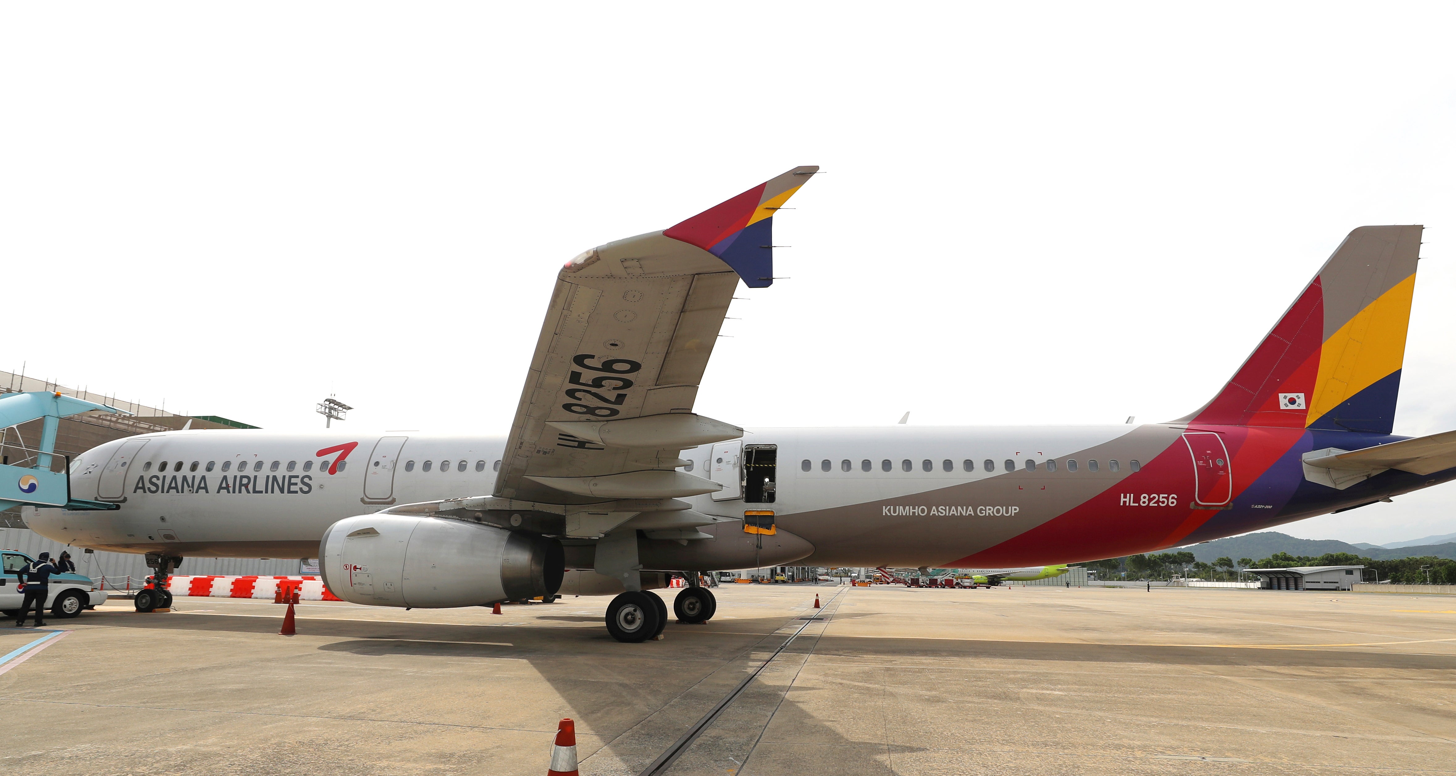 An Asiana Airlines plane is parked as one of the plane's doors suddenly opened at Daegu International Airport in Daegu