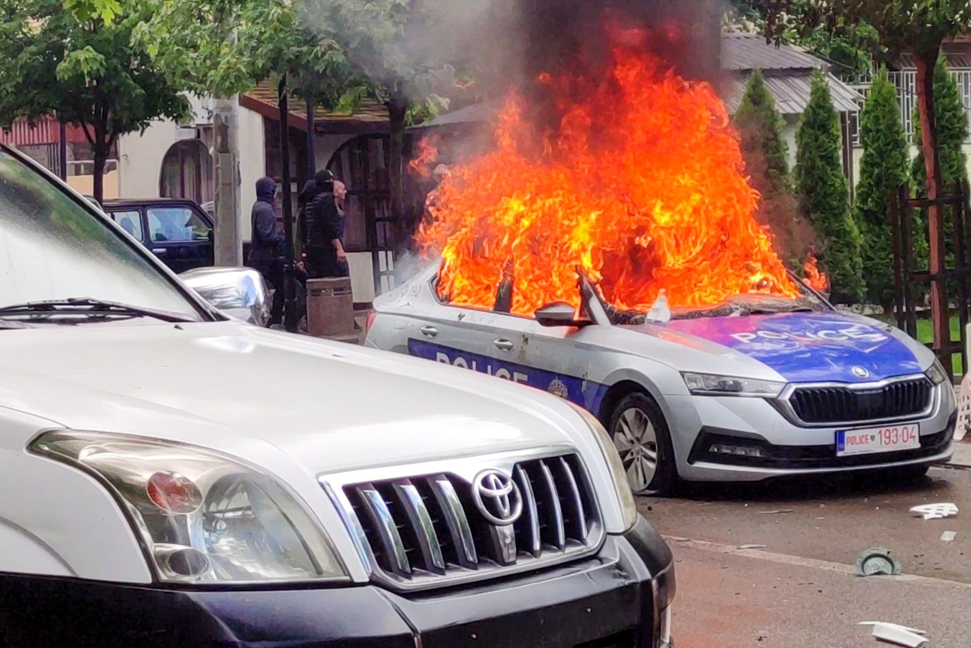 A police car burns in Zvecan, northern Kosovo, on 26 May