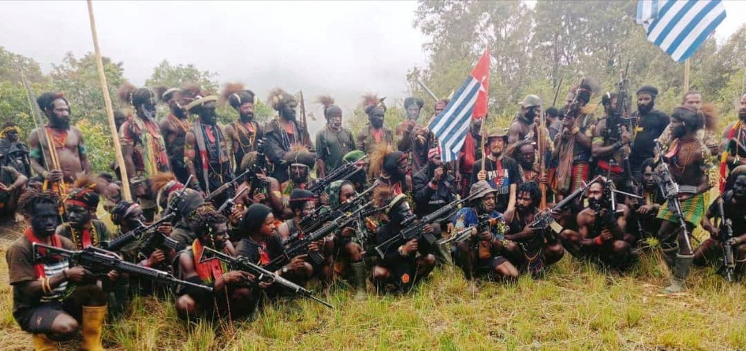 Still from the video released by TPNPB shows New Zealand pilot Philip Mehrtens sitting among separatist fighters and holding their flag in Indonesia’s Papua region in this undated handout picture released on 26 May