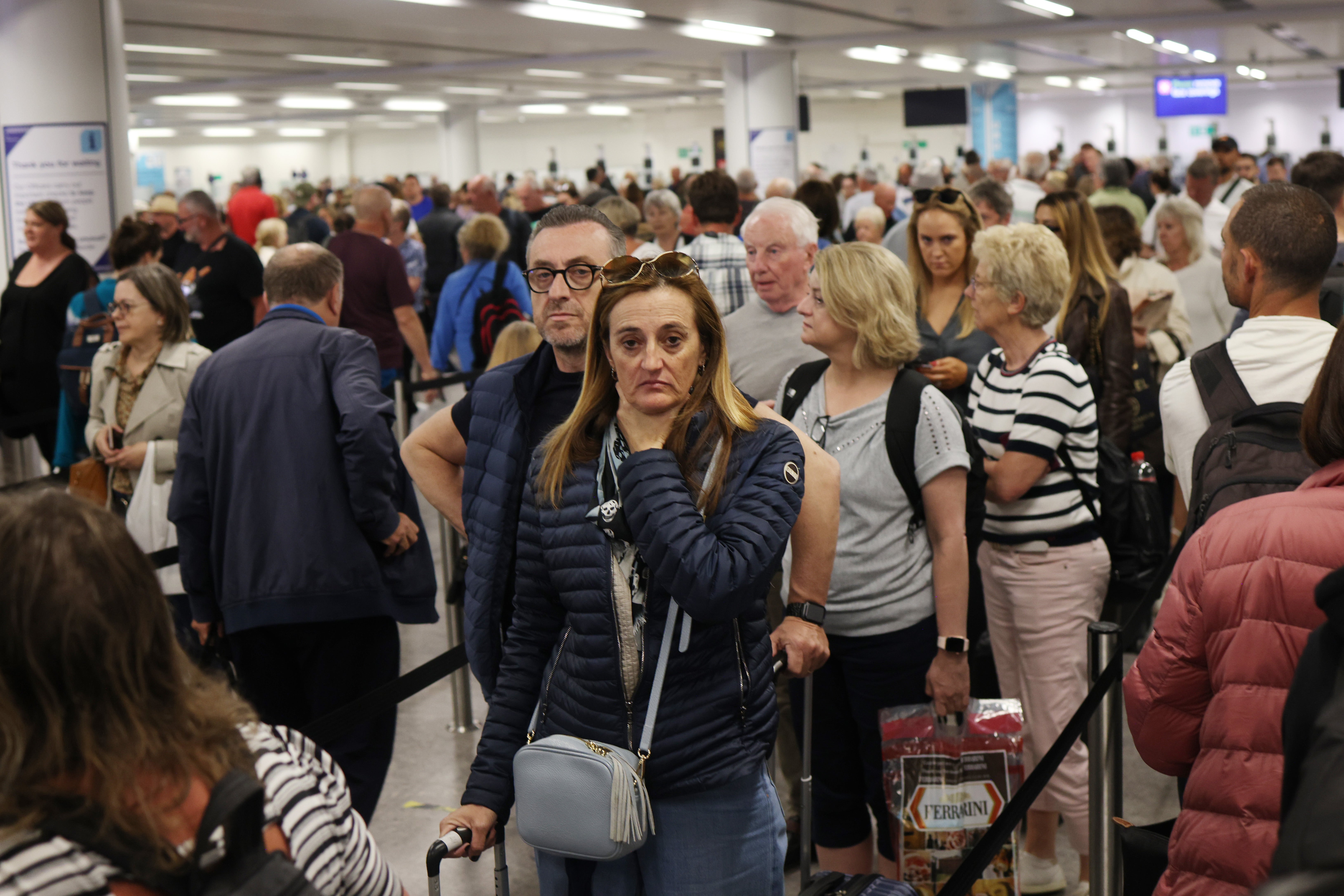 Passengers queue at Gatwick Airport as electronic passport gates fail across the UK