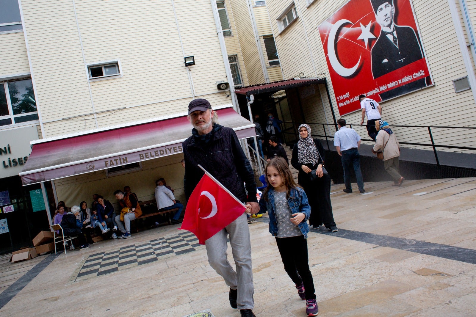 A voter and a child emerge from a polling station in Istanbul