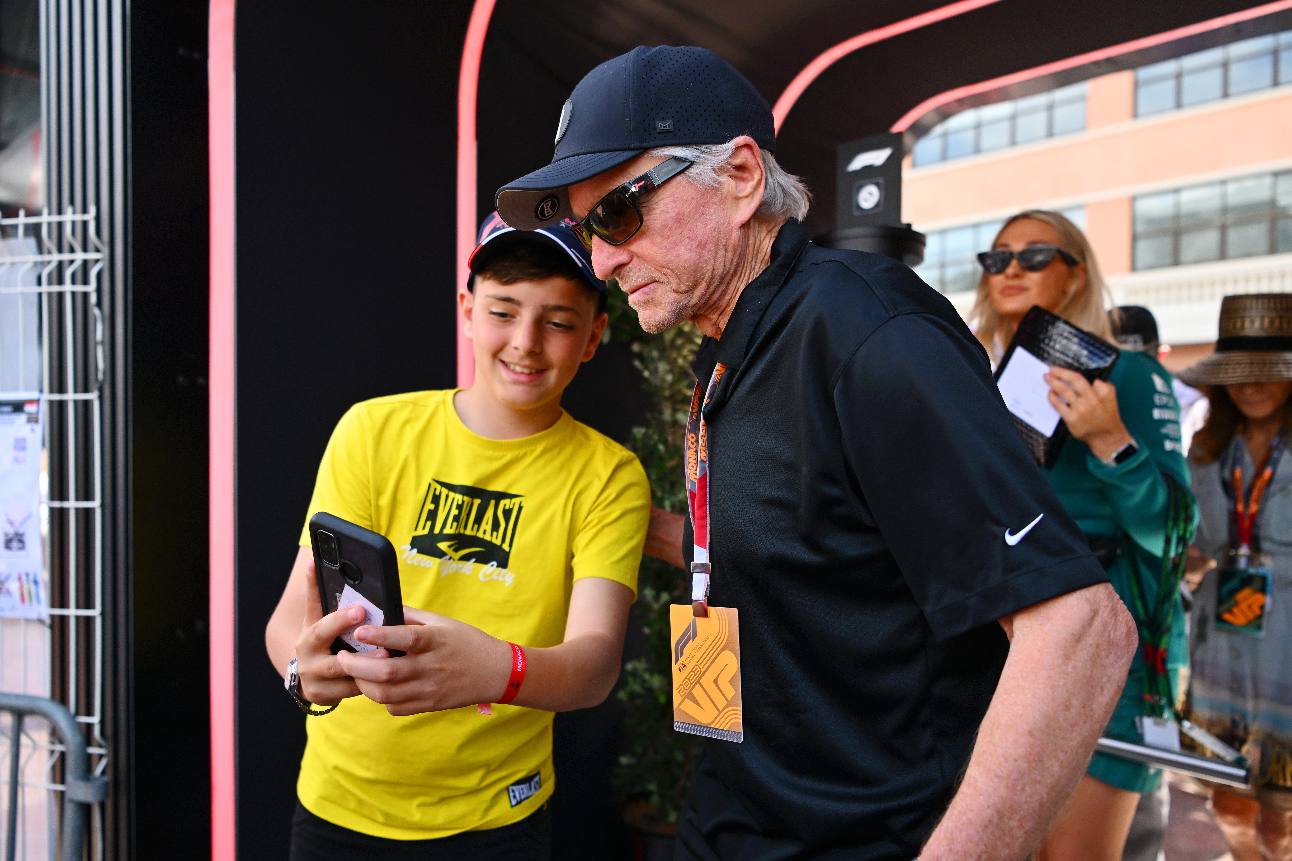 Michael Douglas greets a fan in the Paddock prior to the F1 Grand Prix of Monaco at Circuit de Monaco on May 28, 2023