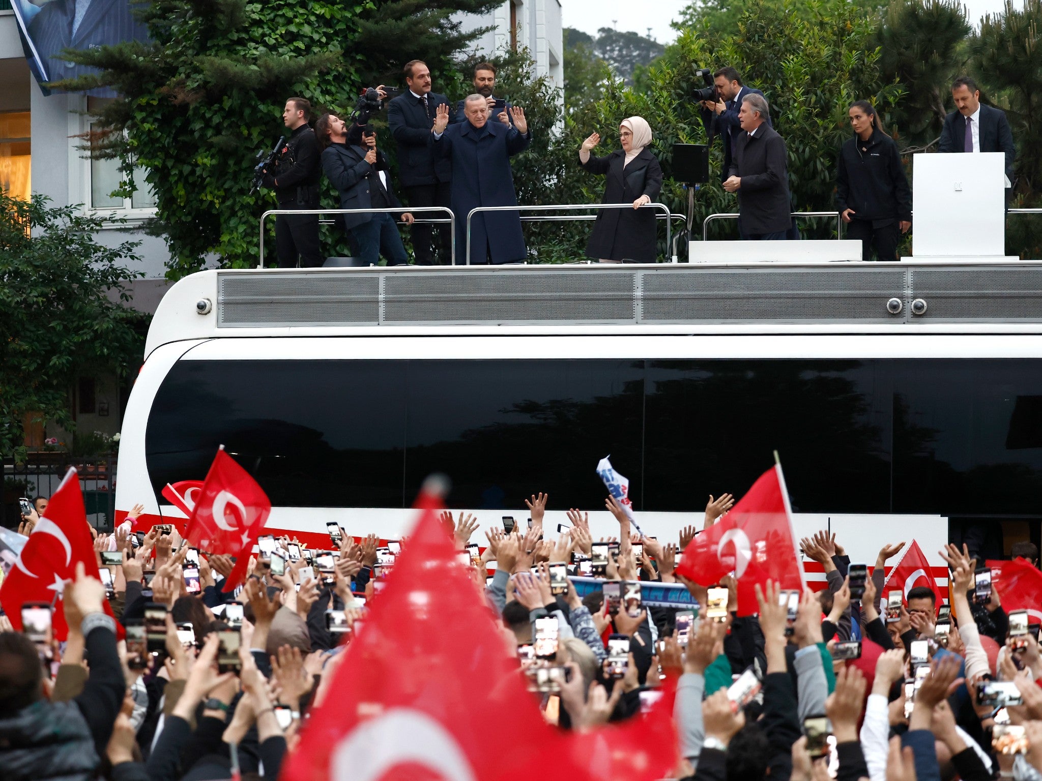 Recep Tayyip Erdogan, centre, waves to supporters as he claims victory in Istanbul