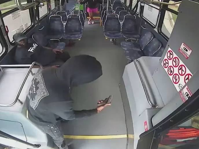 A wild shootout between a bus driver and passenger on a moving vehicle that left both injured was captured on security video