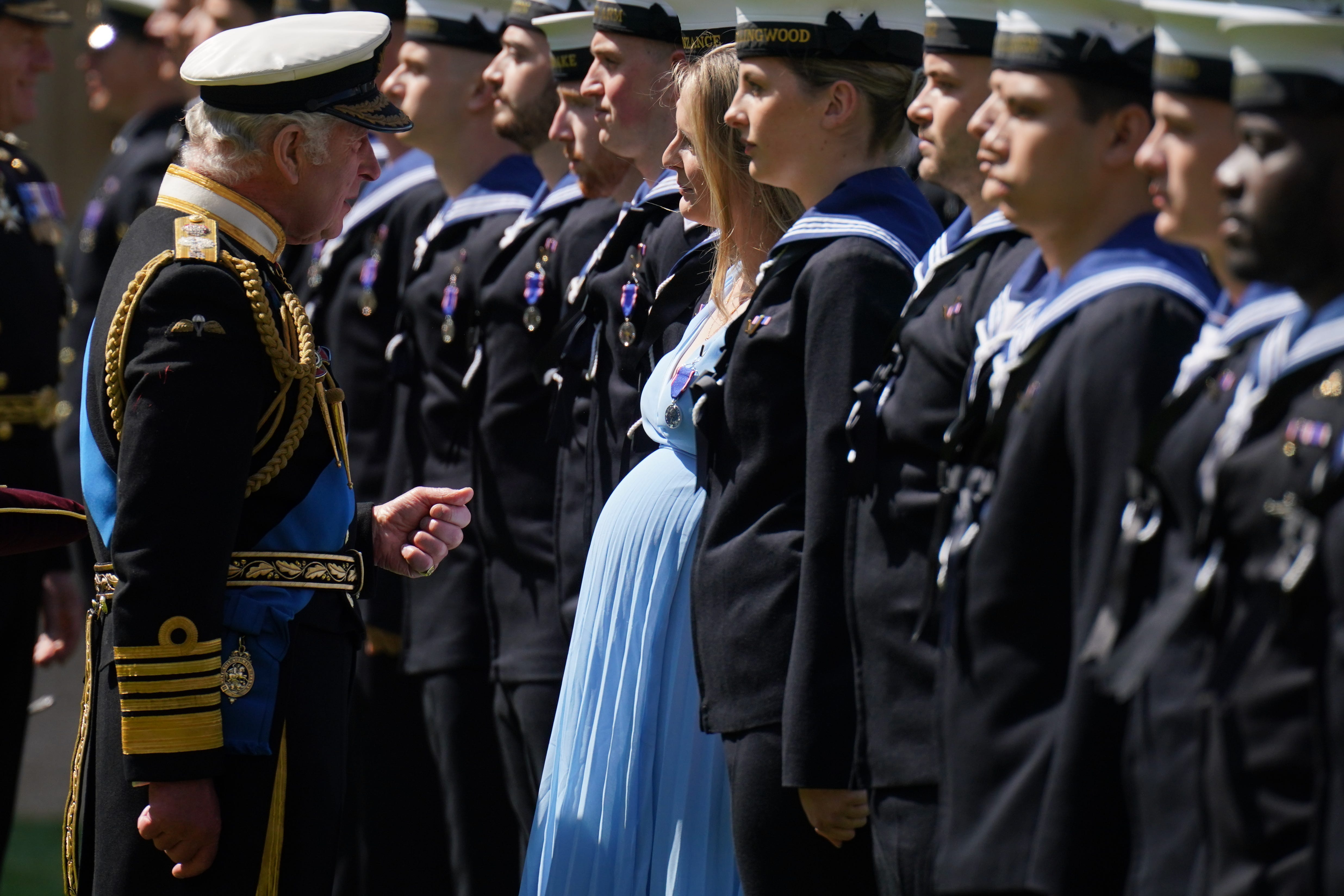 The King presents seven months pregnant Medical Assistant Paisley Chambers-Smith with the Royal Victorian Order (Jonathan Brady/PA)