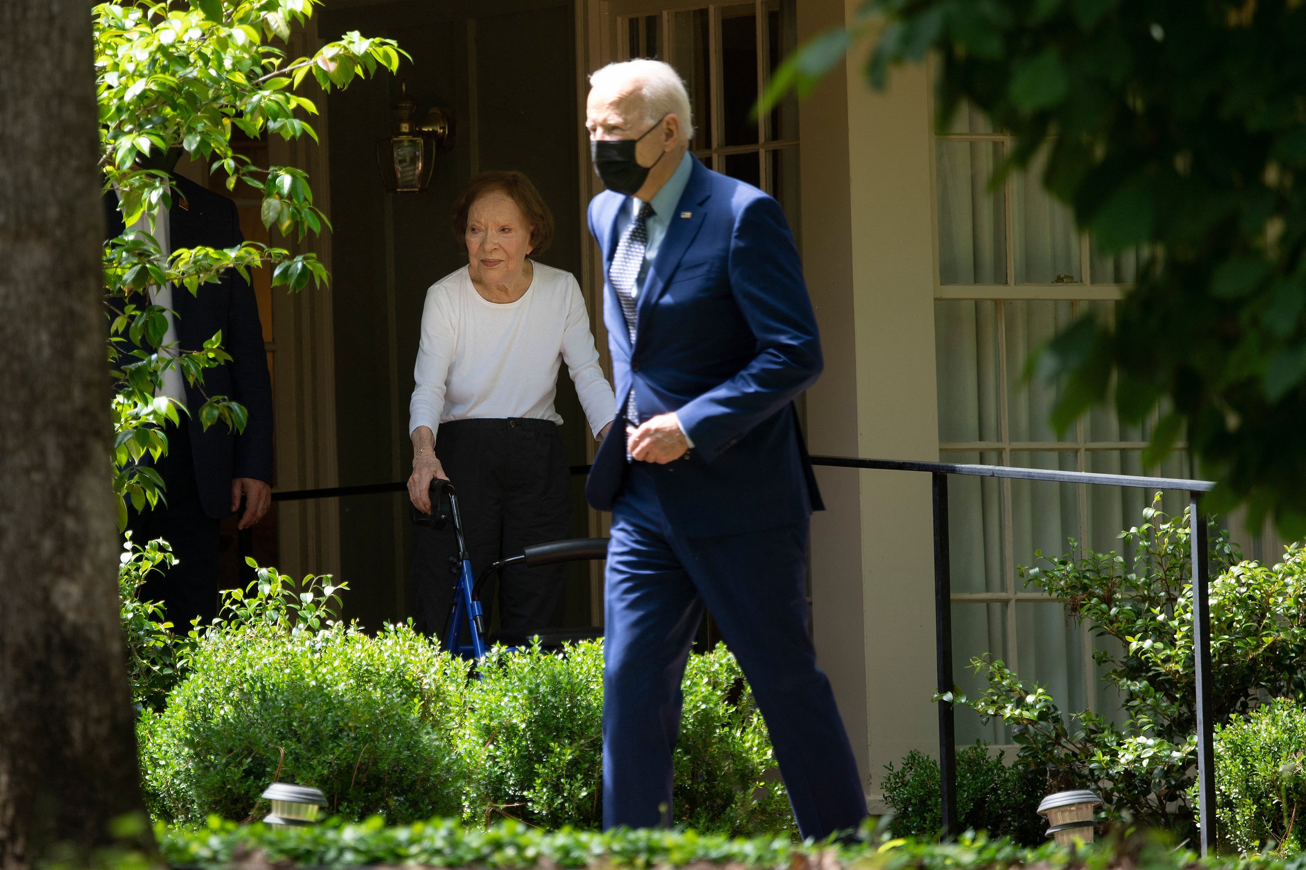 Former First Lady Rosalynn Carter (L) waits as US President Joe Biden leaves after he visited former US President Jimmy Carter, April 29, 2021, in Plains, Georgia.