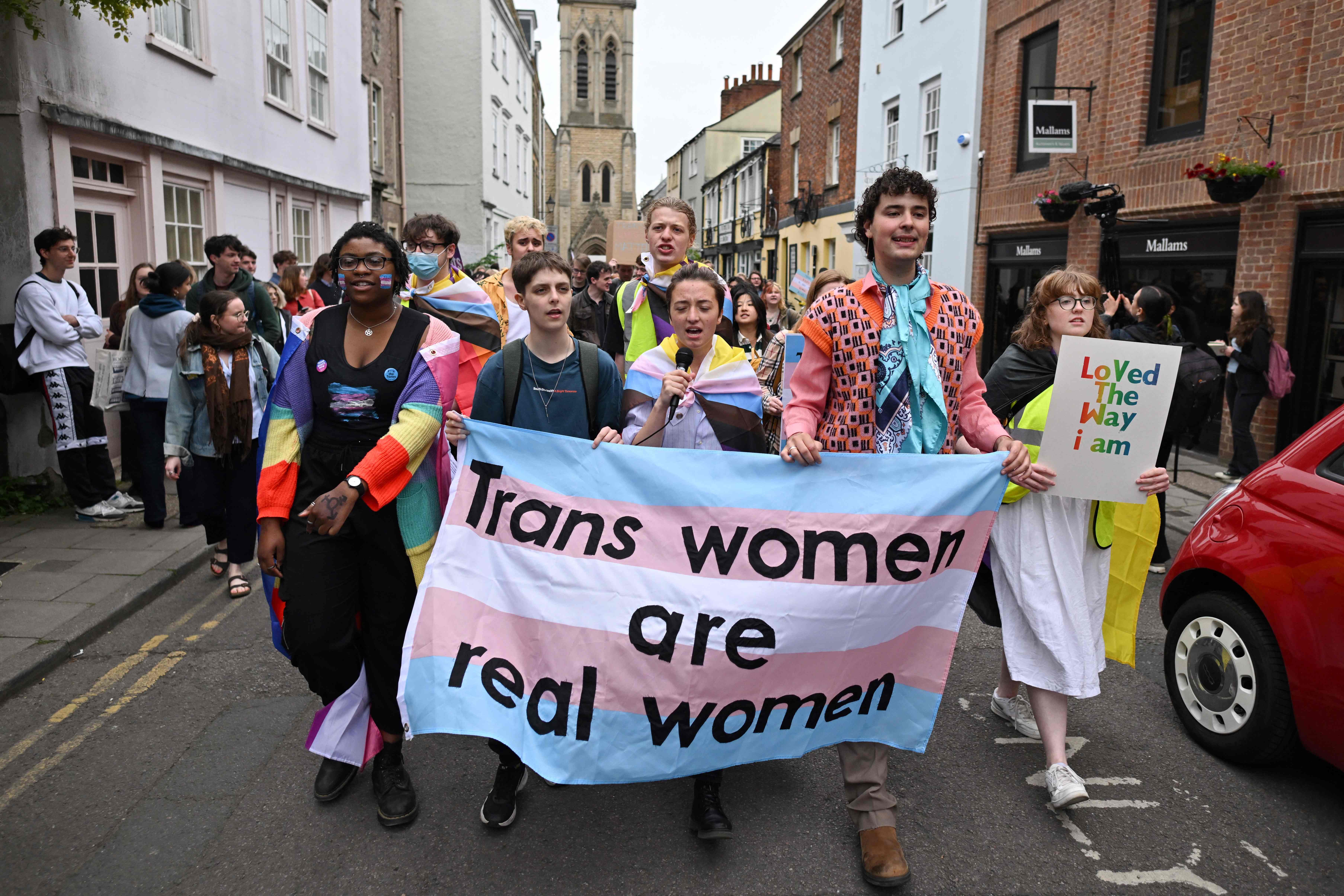 Campaigners holding banners that read “Resisting by existing” and chanting “Trans rights – human rights” marched towards the 200-year-old debating society, where police were braced for potential clashes