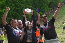 Woman wins famous UK cheese rolling race despite being knocked unconscious