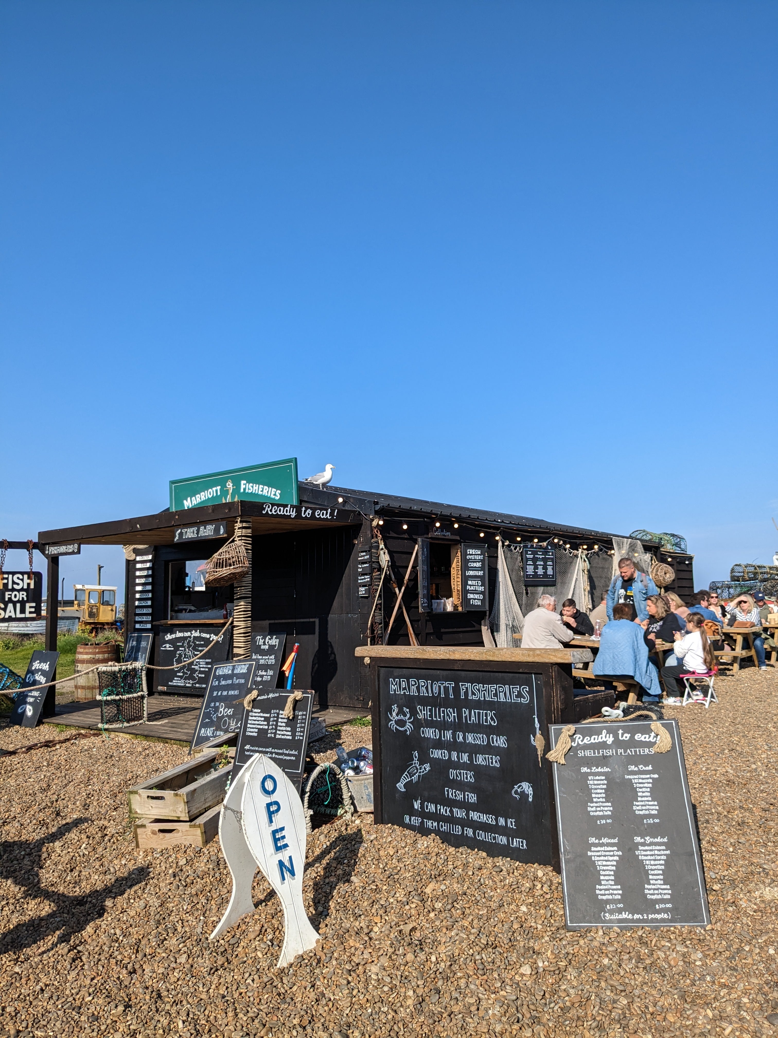 Modest fisherman’s huts sit inches from lobster traps and are laden with menu boards