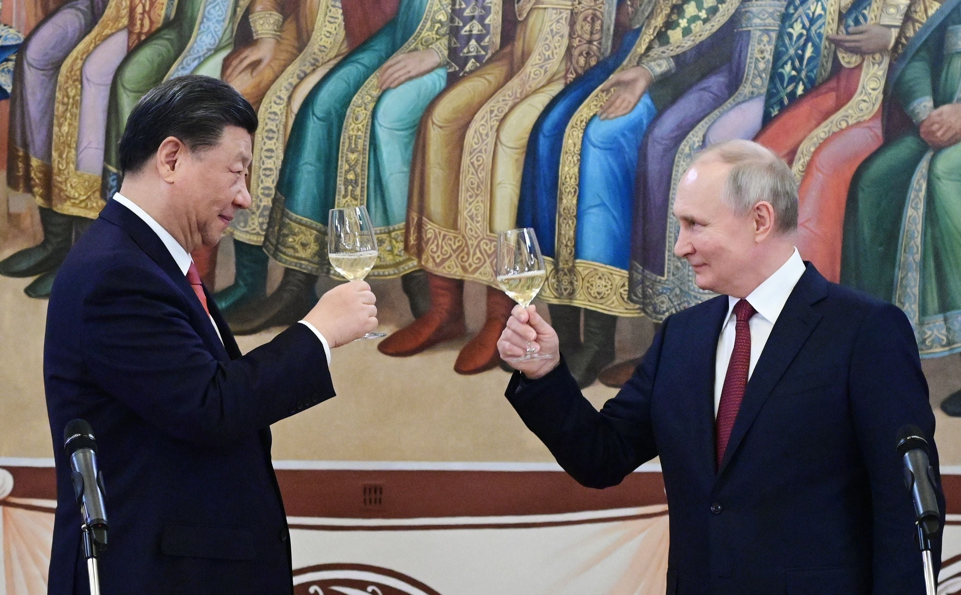 Russian president Vladimir Putin and China's president Xi Jinping make a toast during a reception following their talks at the Kremlin in Moscow on 21 March