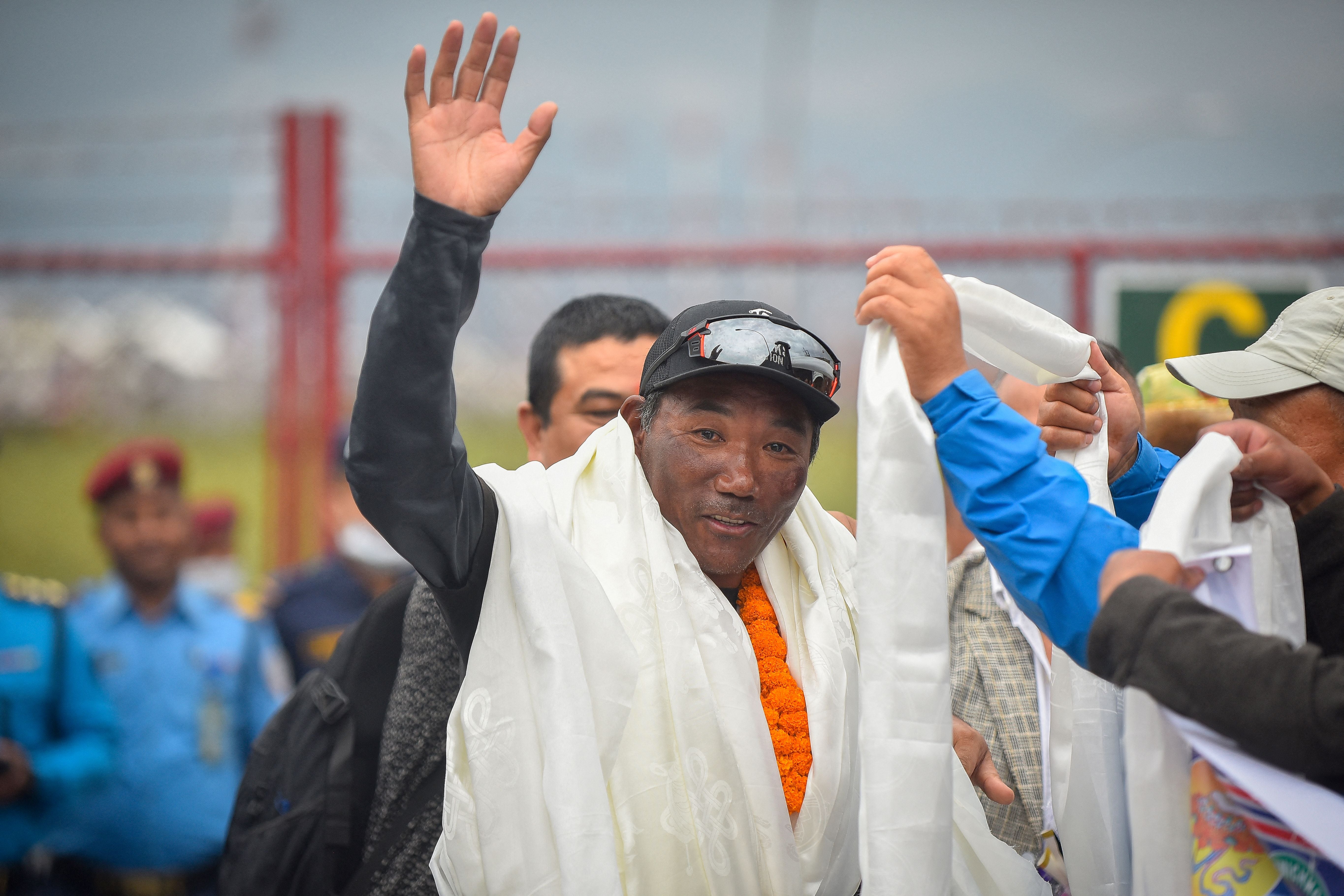 File. Nepali climber Kami Rita Sherpa who reached the top of Mount Everest on 23 May 2023, for a record 28th time gestures to the crowd upon arriving at the Tribhuvan airport in Kathmandu on 25 May 2023