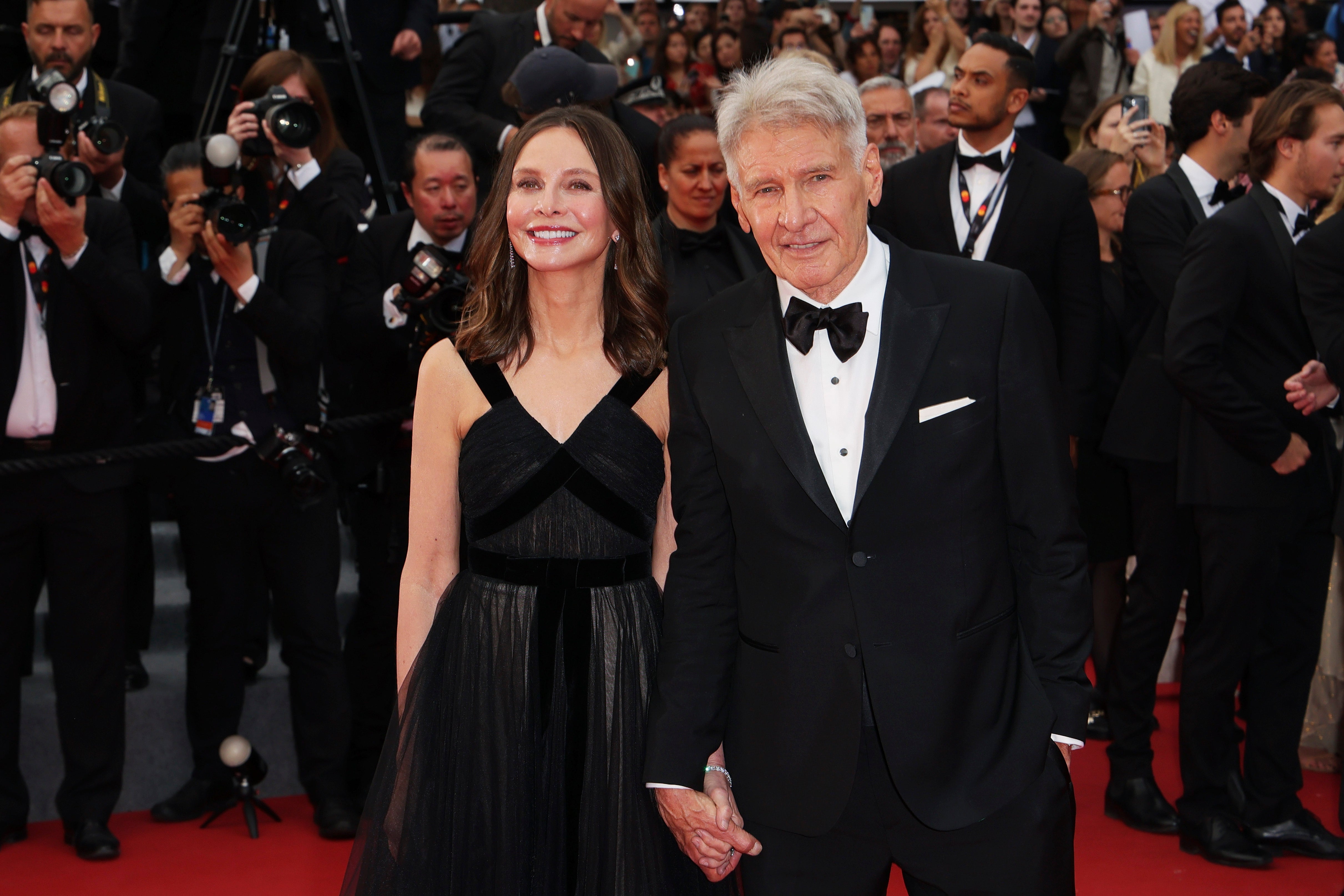 Harrison Ford and Calista Flockhart attend the Indiana Jones and The Dial of Destiny red carpet at 2023 Cannes Film Festival