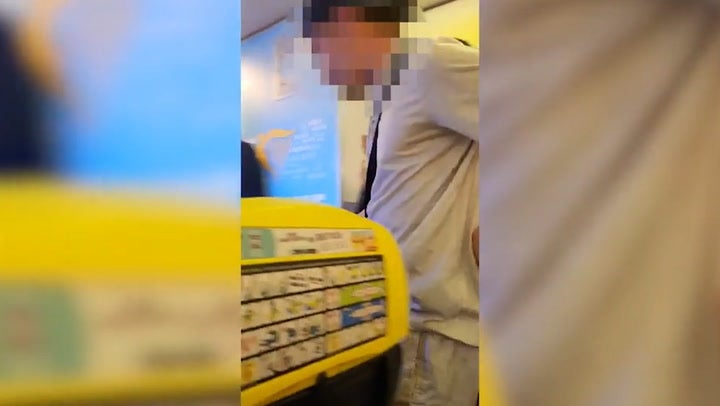 Moment police storm Ryanair flight after man caught smoking in plane toilet