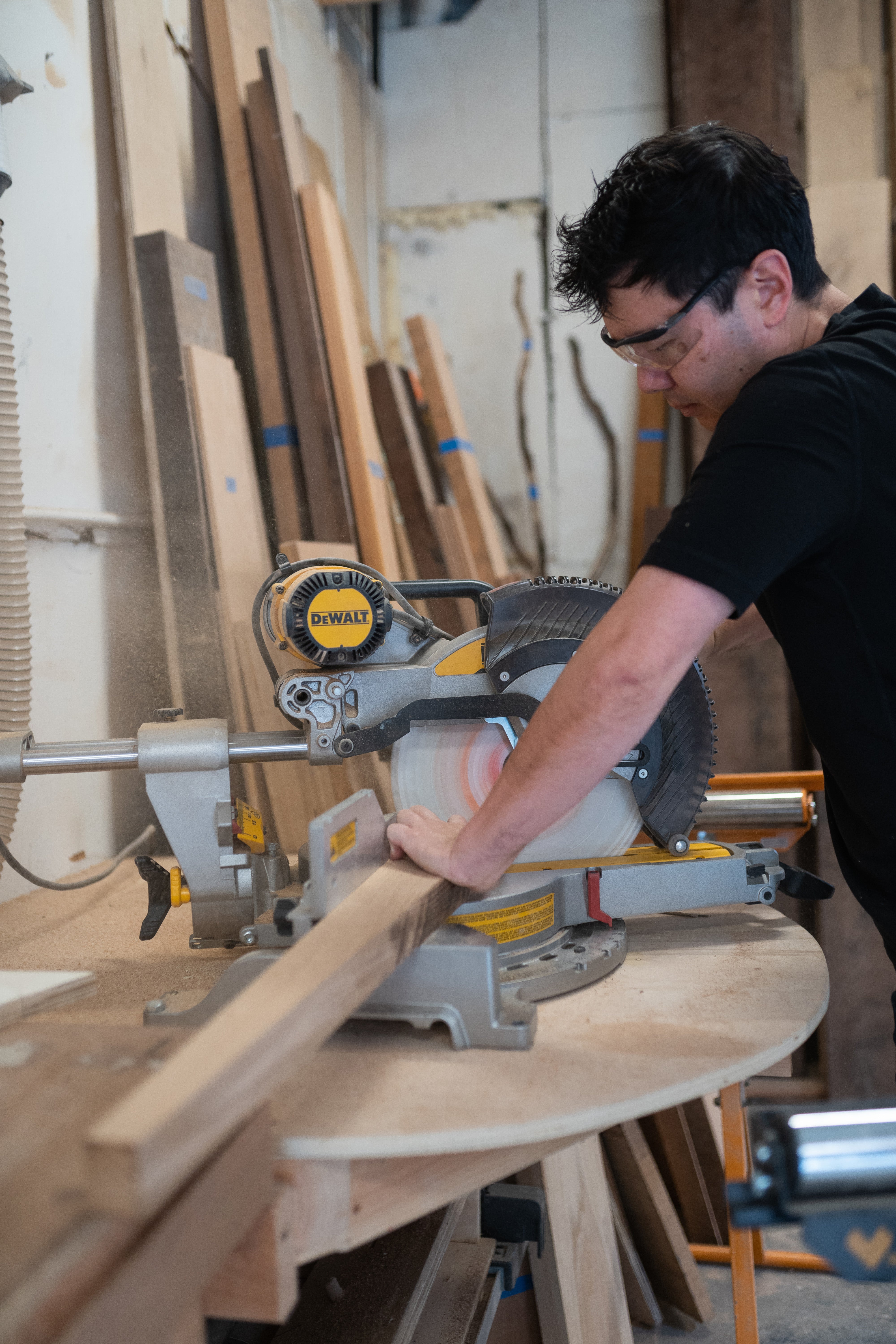 Haomiao cuts wood for one of the projects he and his wife are working on