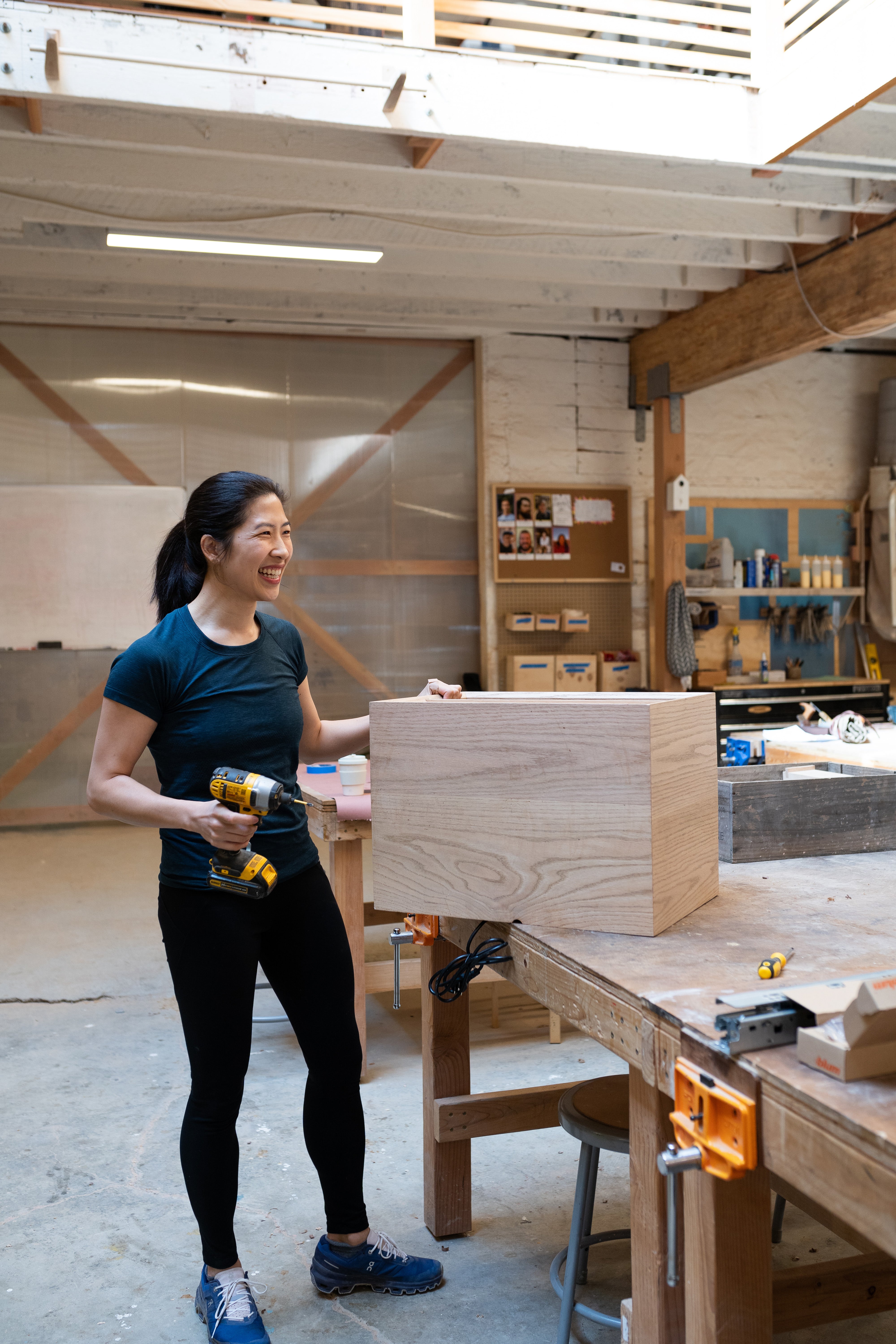 Lydia works on a floating nightstand that’s nearly ready to be installed