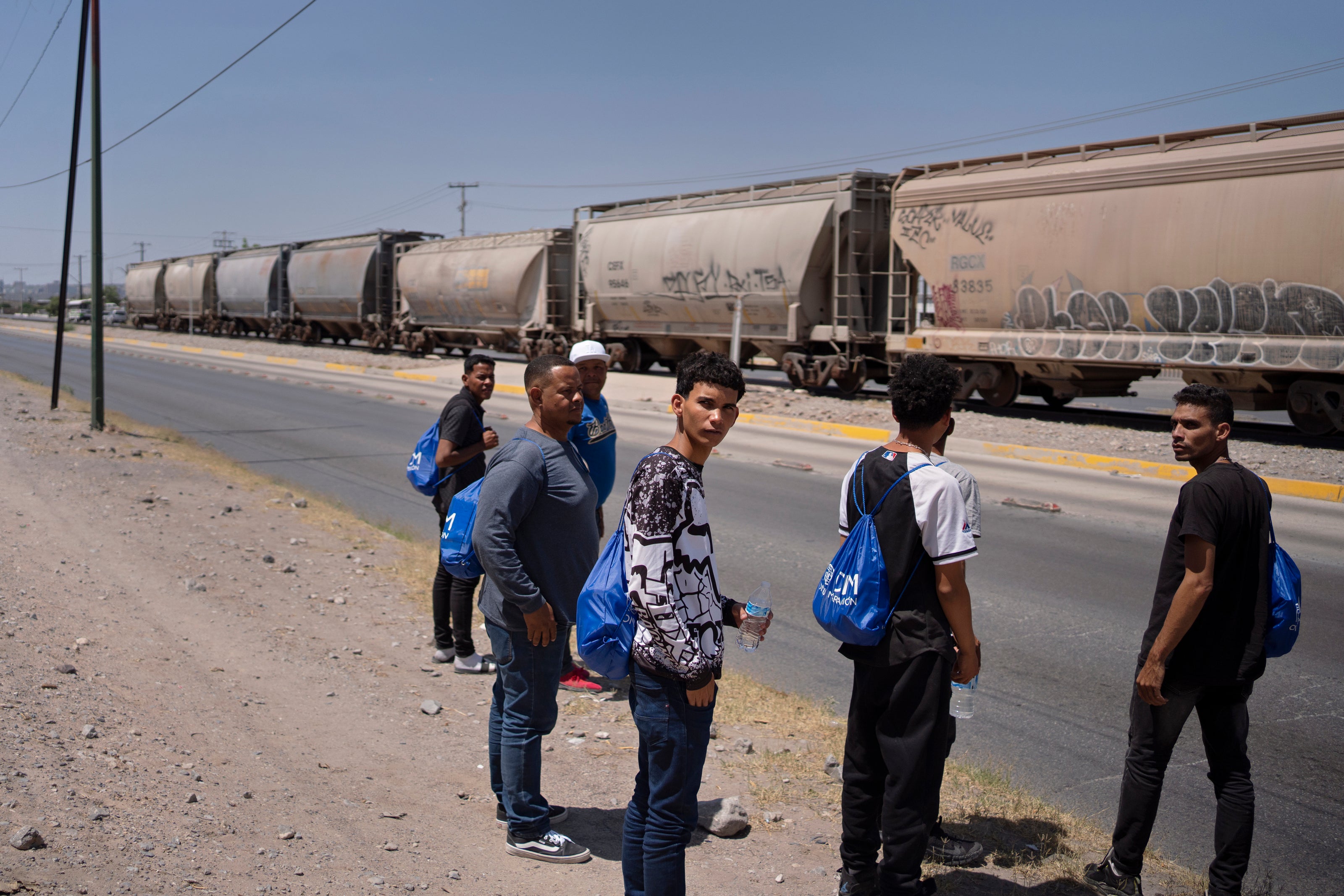 Venezuelans get off a bus across the street from a government-run shelter in Juárez on 12 May