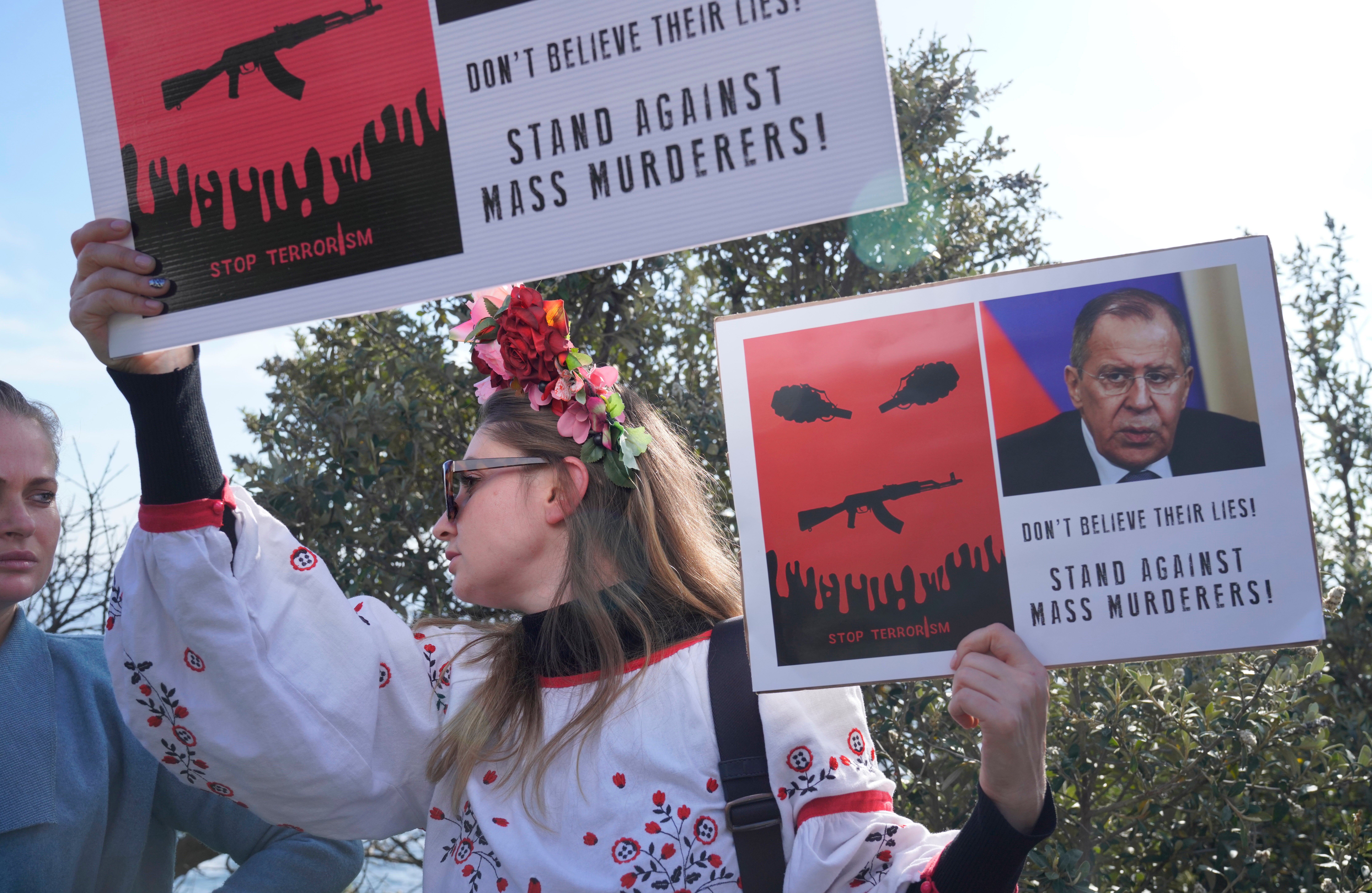 Demonstrators protest against the war in Ukraine at a venue in which Russian and Chinese foreign ministers are set to meet with their counterparts from the Brics economic bloc