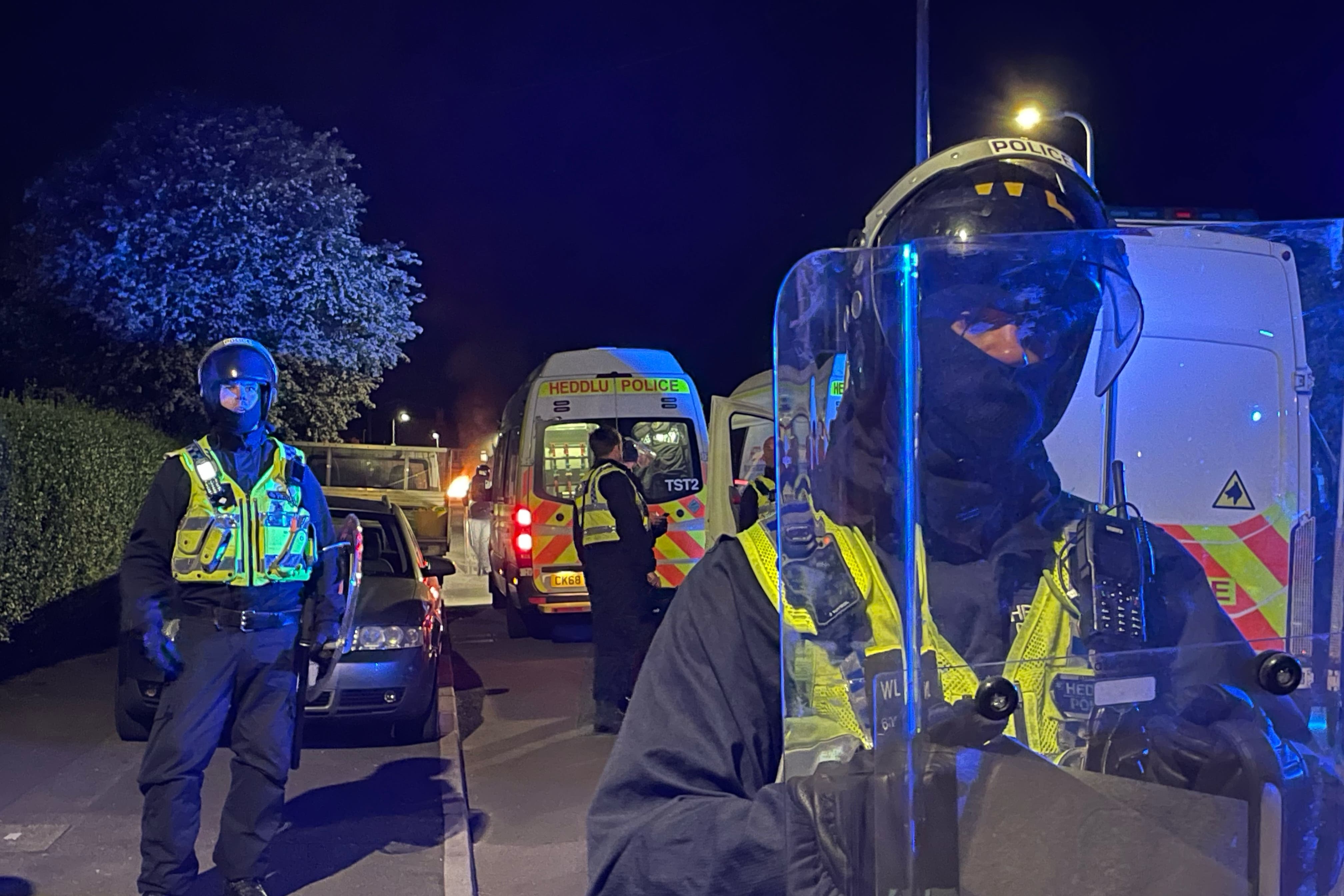 Police officers on Howell Road in Cardiff as they face a ‘large scale disorder’ at the scene of a serious road traffic collision on Snowden Road in Ely (Bronwen Weatherby/PA)